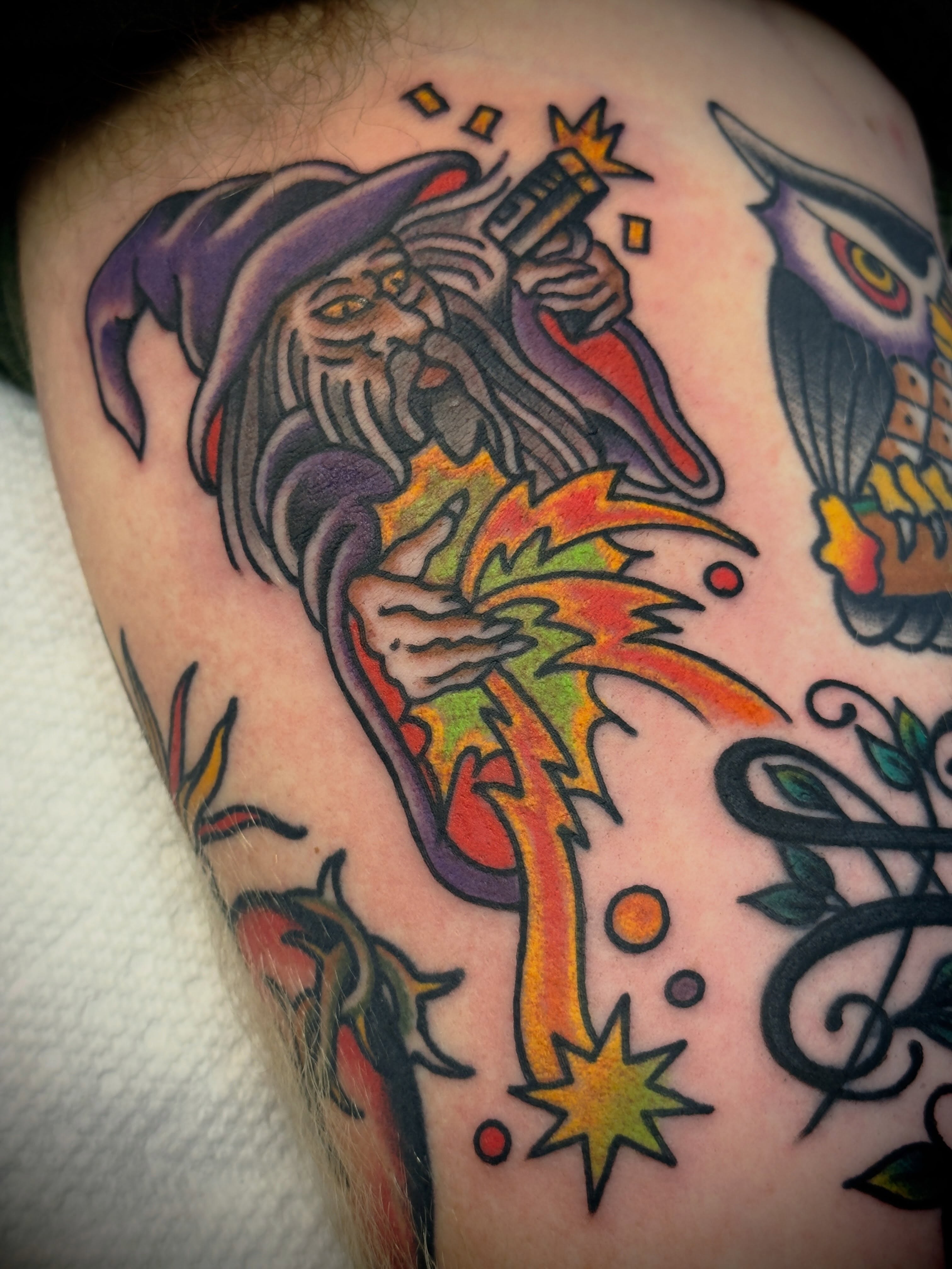 Wizard casting fire American traditional tattoo on the shoulder by Andrew Slater