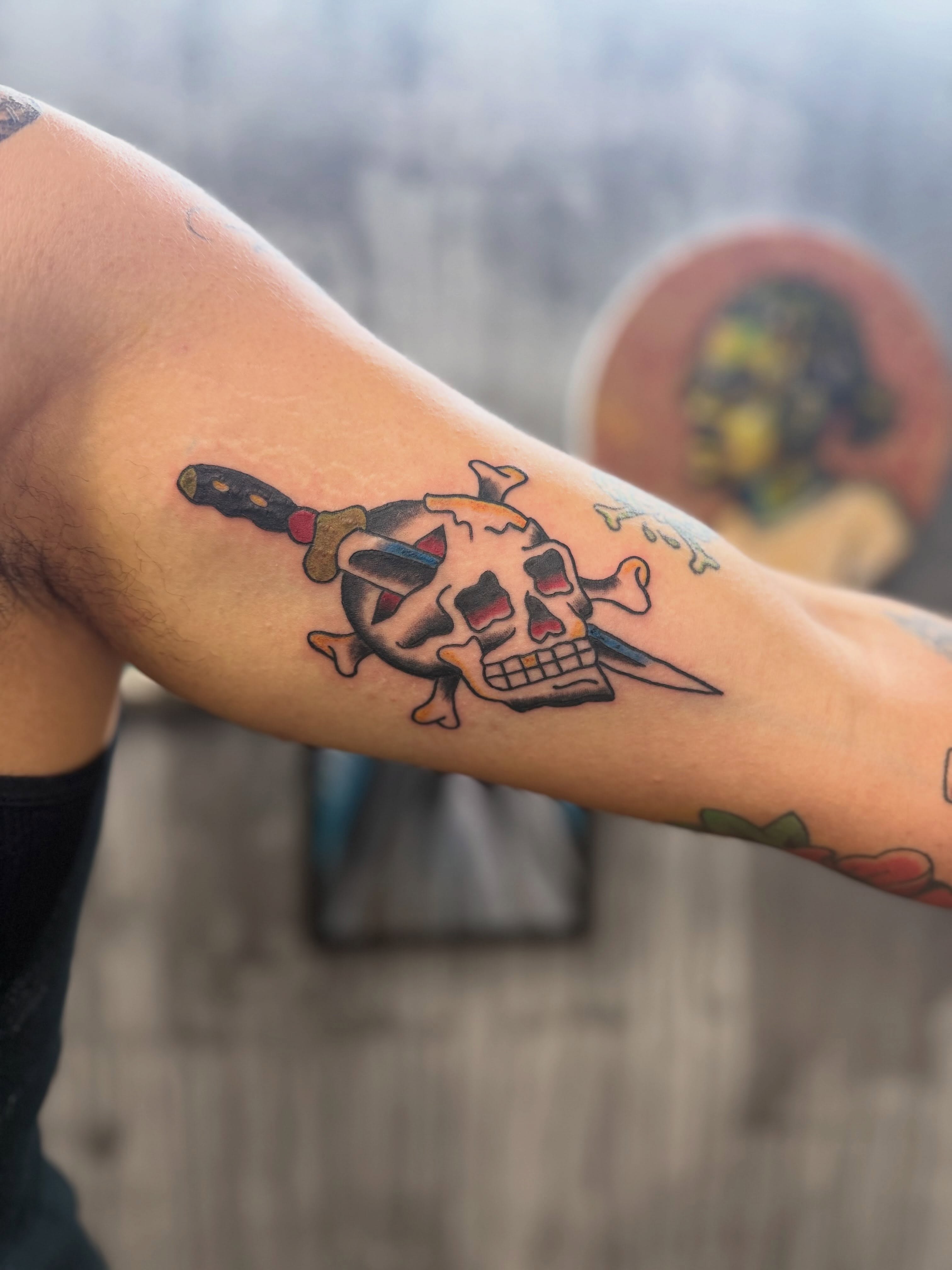 Skull and crossbones with dagger American traditional tattoo on the forearm by Camilo