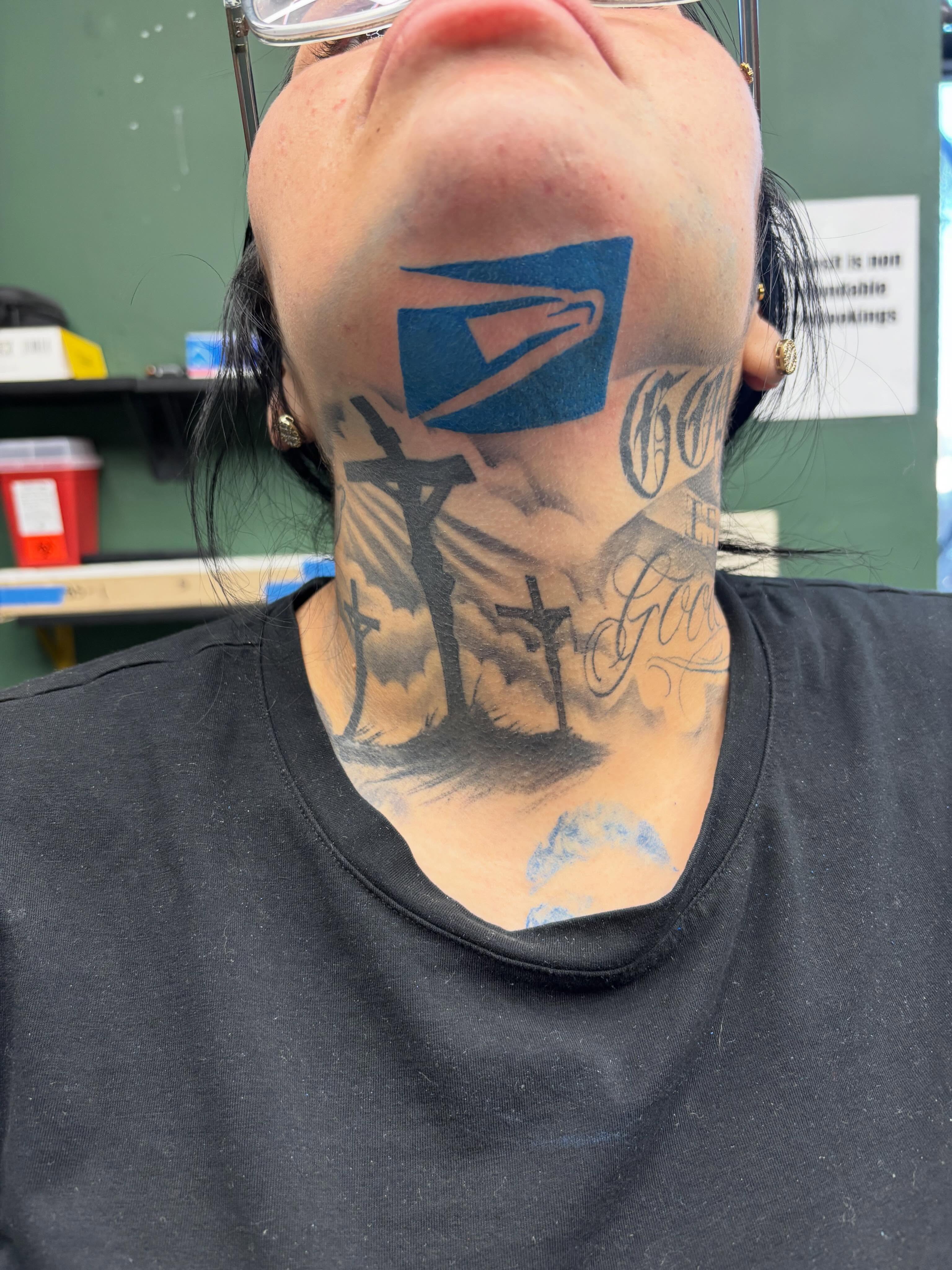 Postal logo black and grey tattoo on the neck by Shadows Tattoos