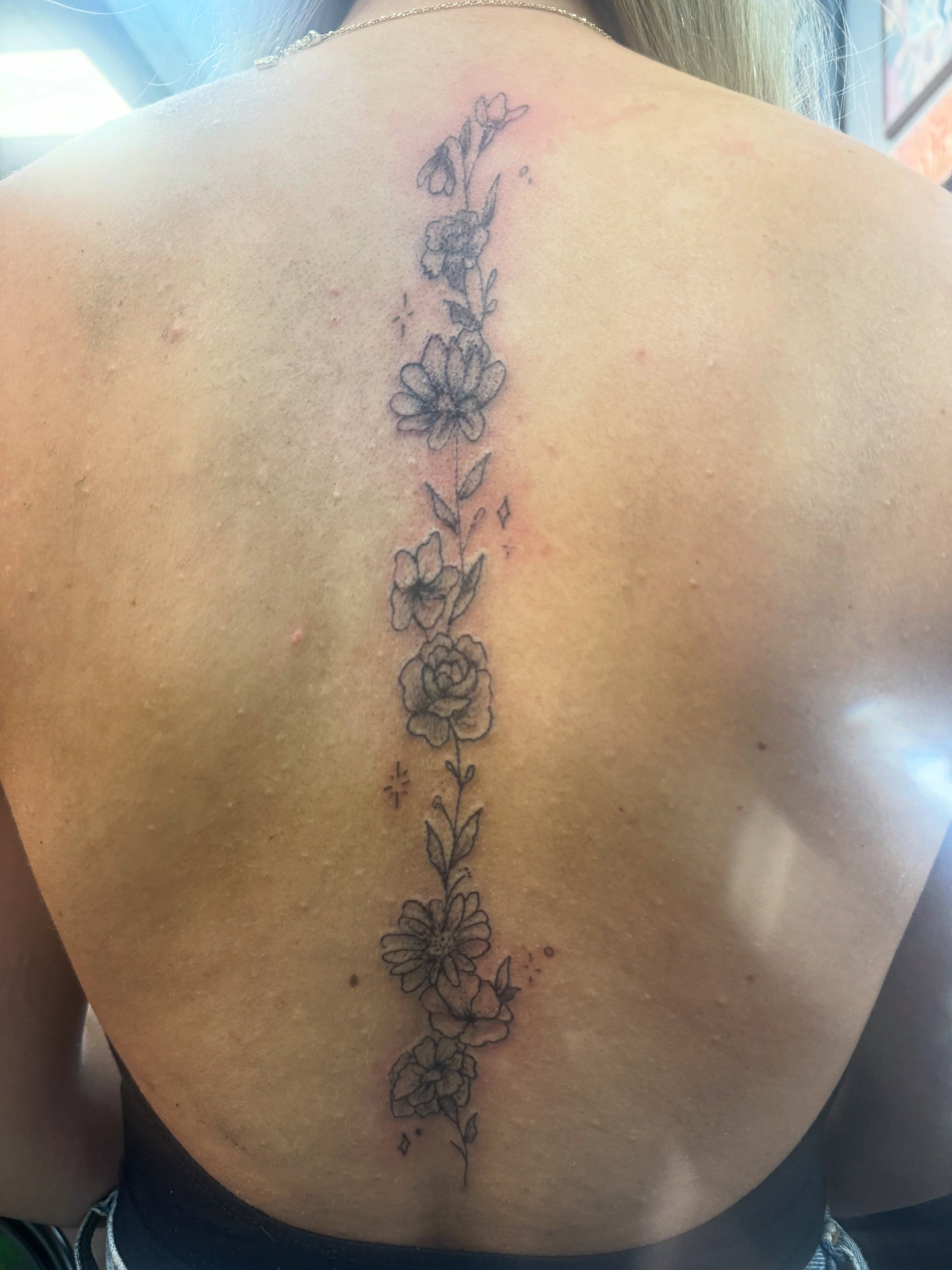 Floral vine black and grey tattoo on the back by Lexy