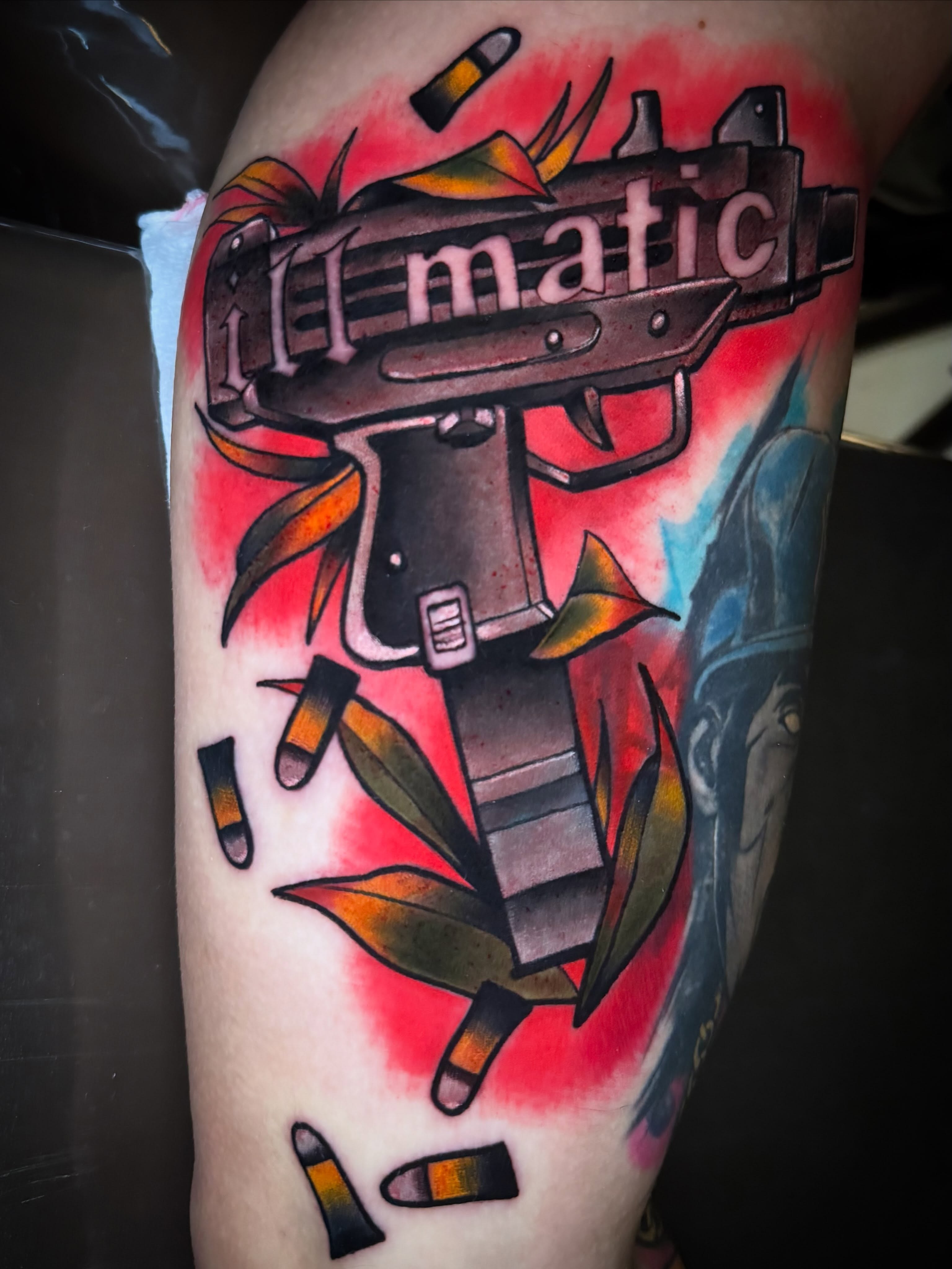 Machine gun American traditional tattoo on the thigh by Eric Zuluaga