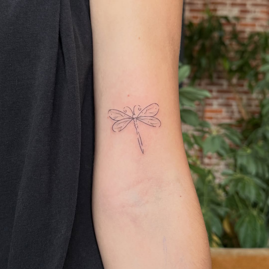 Dragonfly fine line tattoo on the forearm by Fine Line Tattoos