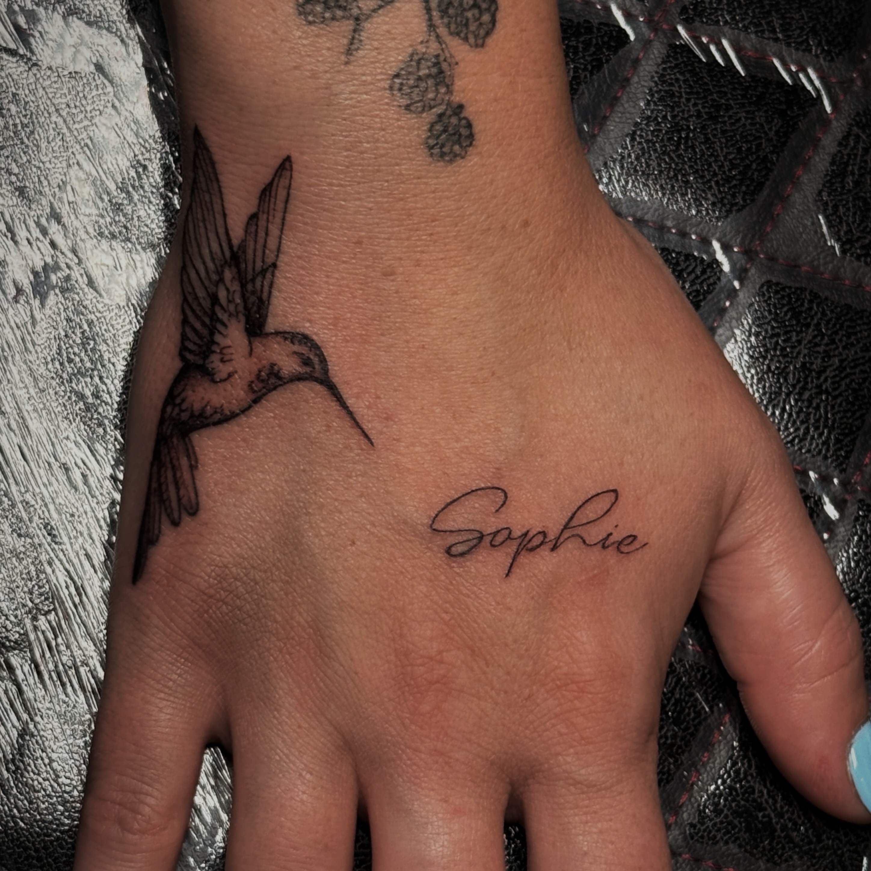 Hummingbird black and grey tattoo on the hand by Kaylee Castleton, Tooele, Utah