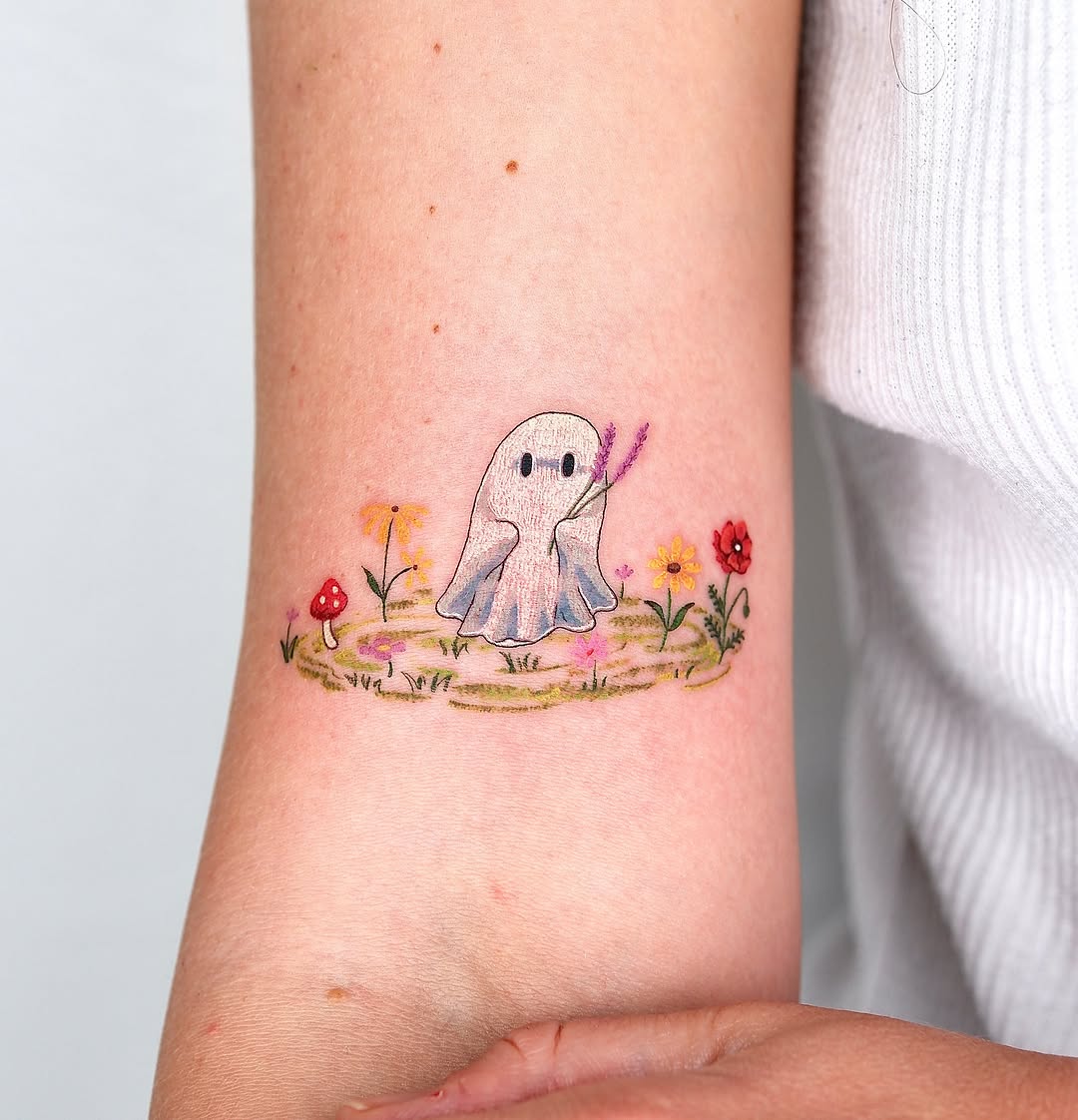 Ghost in a meadow watercolor tattoo on the forearm by 타투 Seon 컬러타투