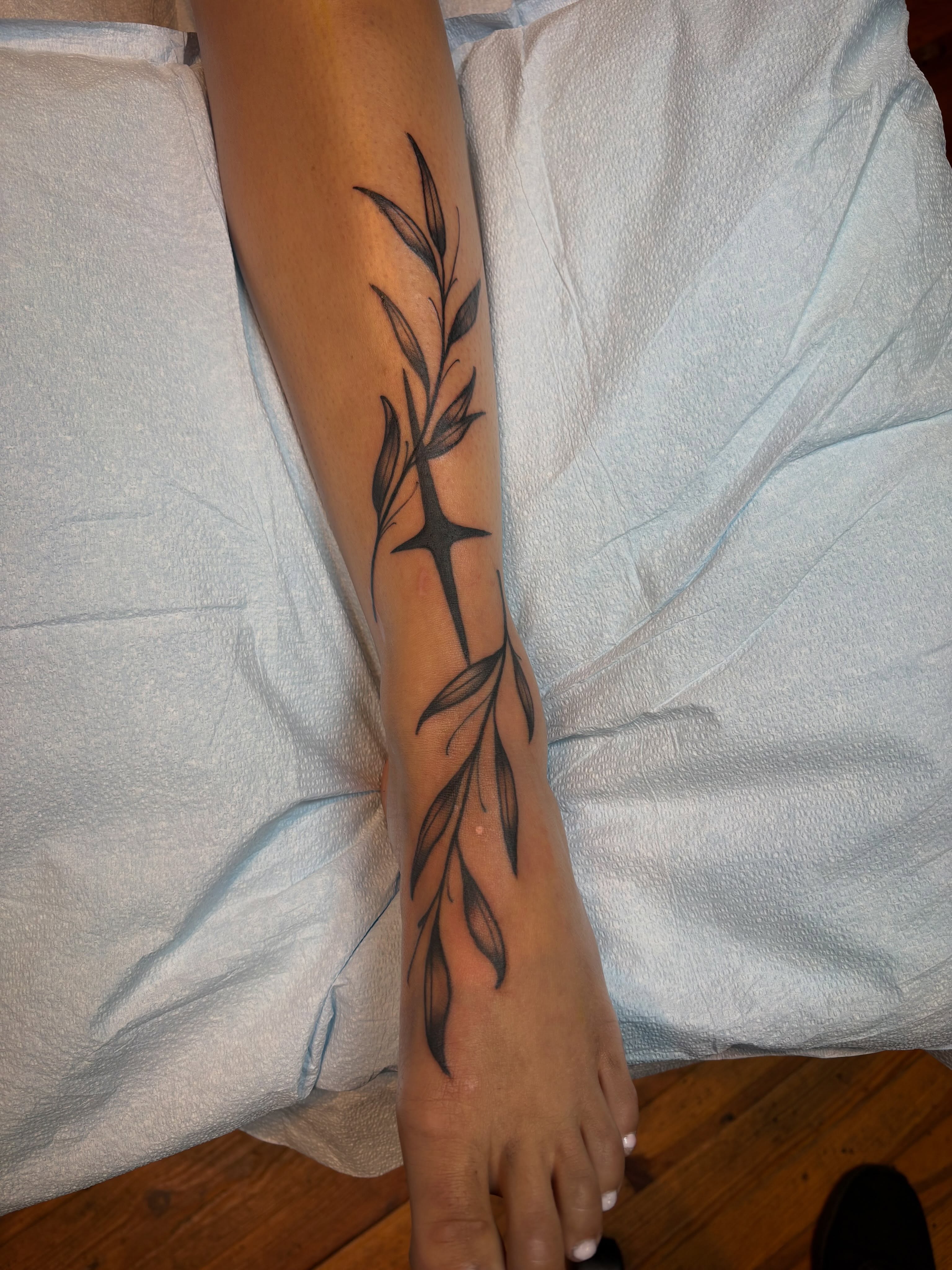 Branch with leaves black and grey tattoo on the forearm by Cameron Scofield