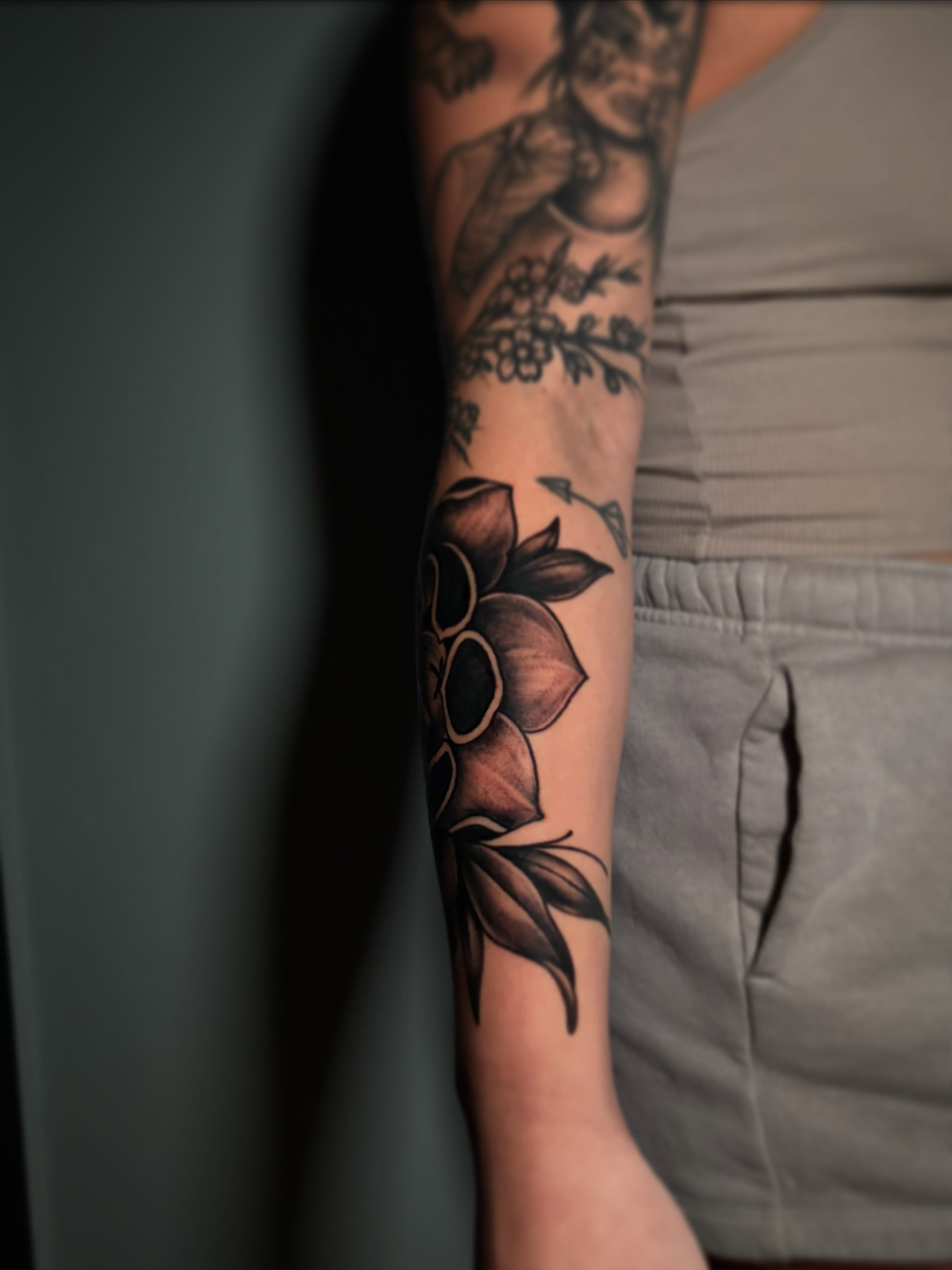 Lotus flower black and grey tattoo on the forearm by Cameron Scofield