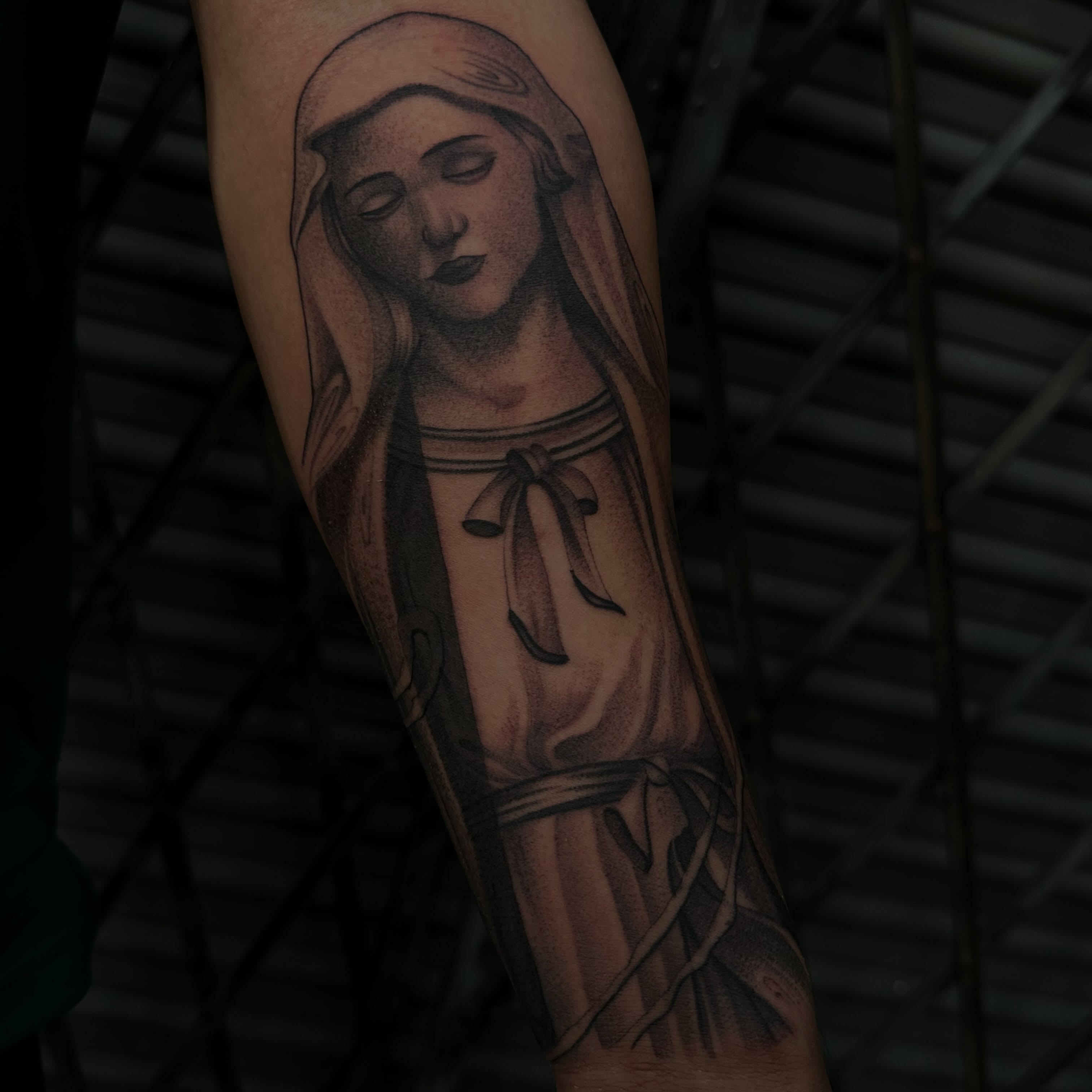 Religious figure black and grey tattoo on the forearm by San Diego Tattoo Artist