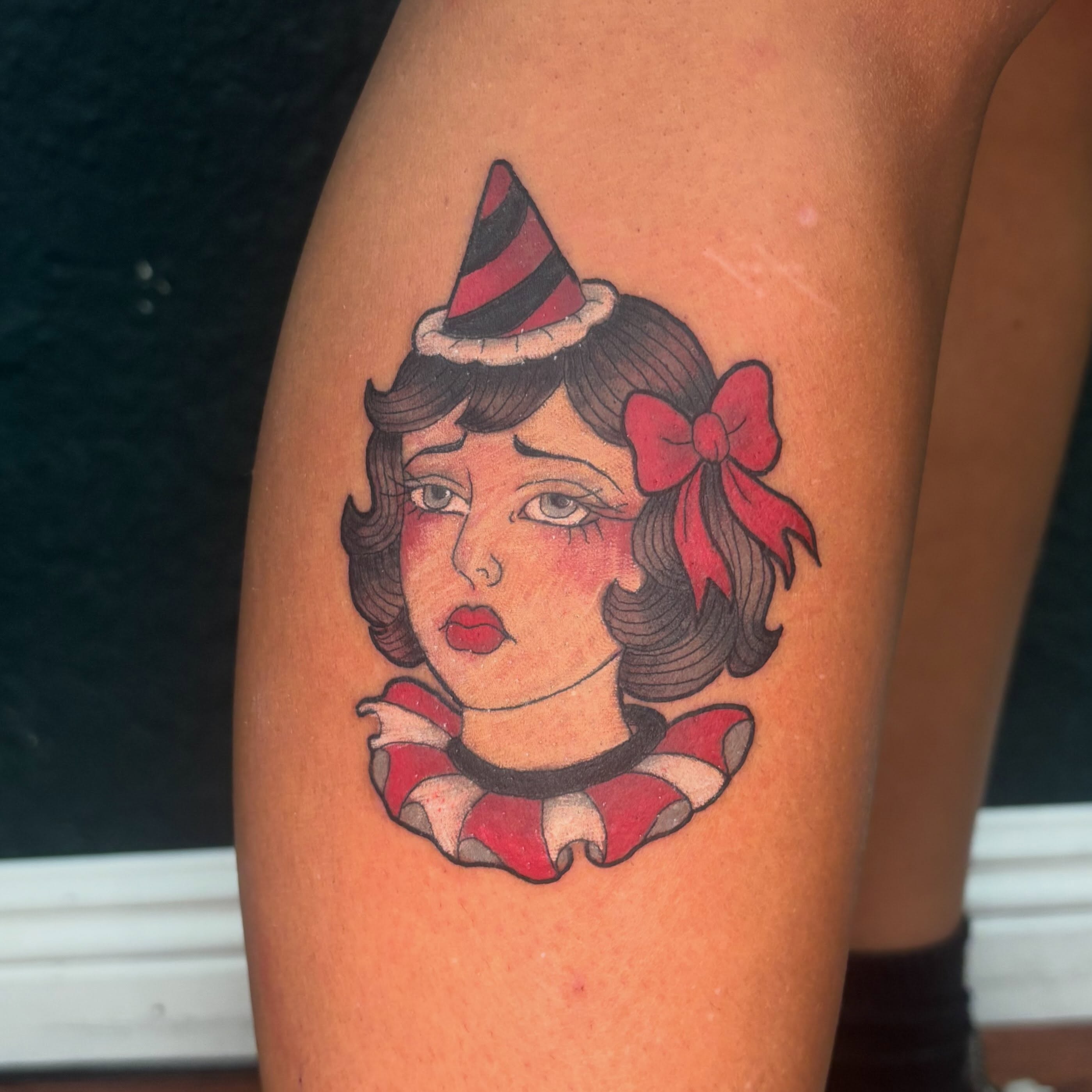 Clown girl American traditional tattoo on the thigh by Emma ๐