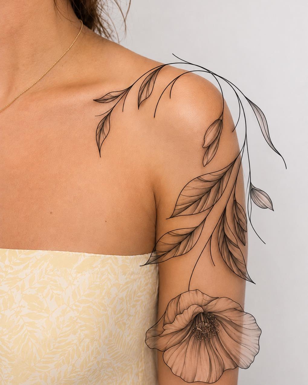 Floral fine line tattoo on the shoulder by Flamboyant