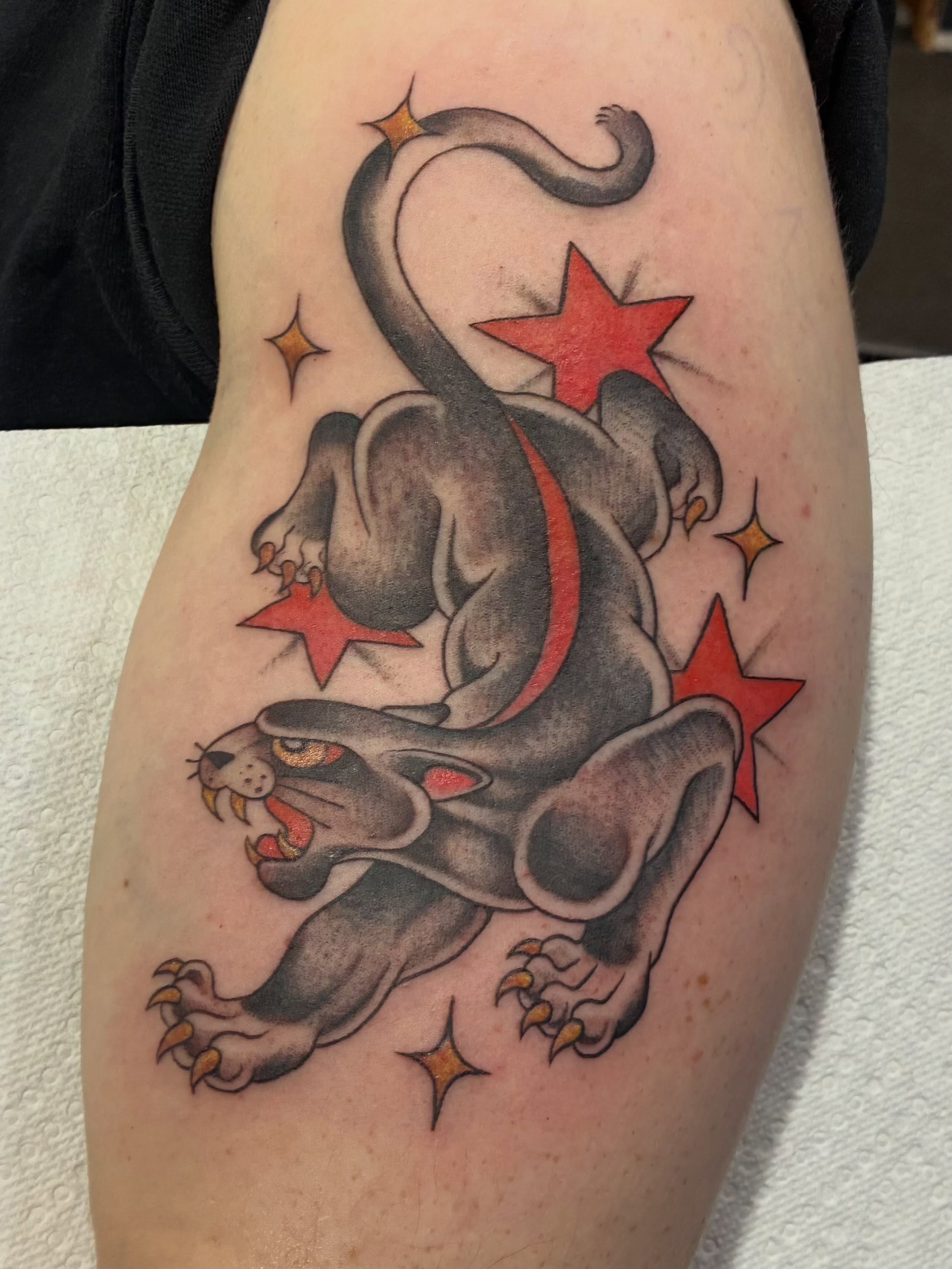 Panther with stars American traditional tattoo on the thigh by Natalie Spuhler