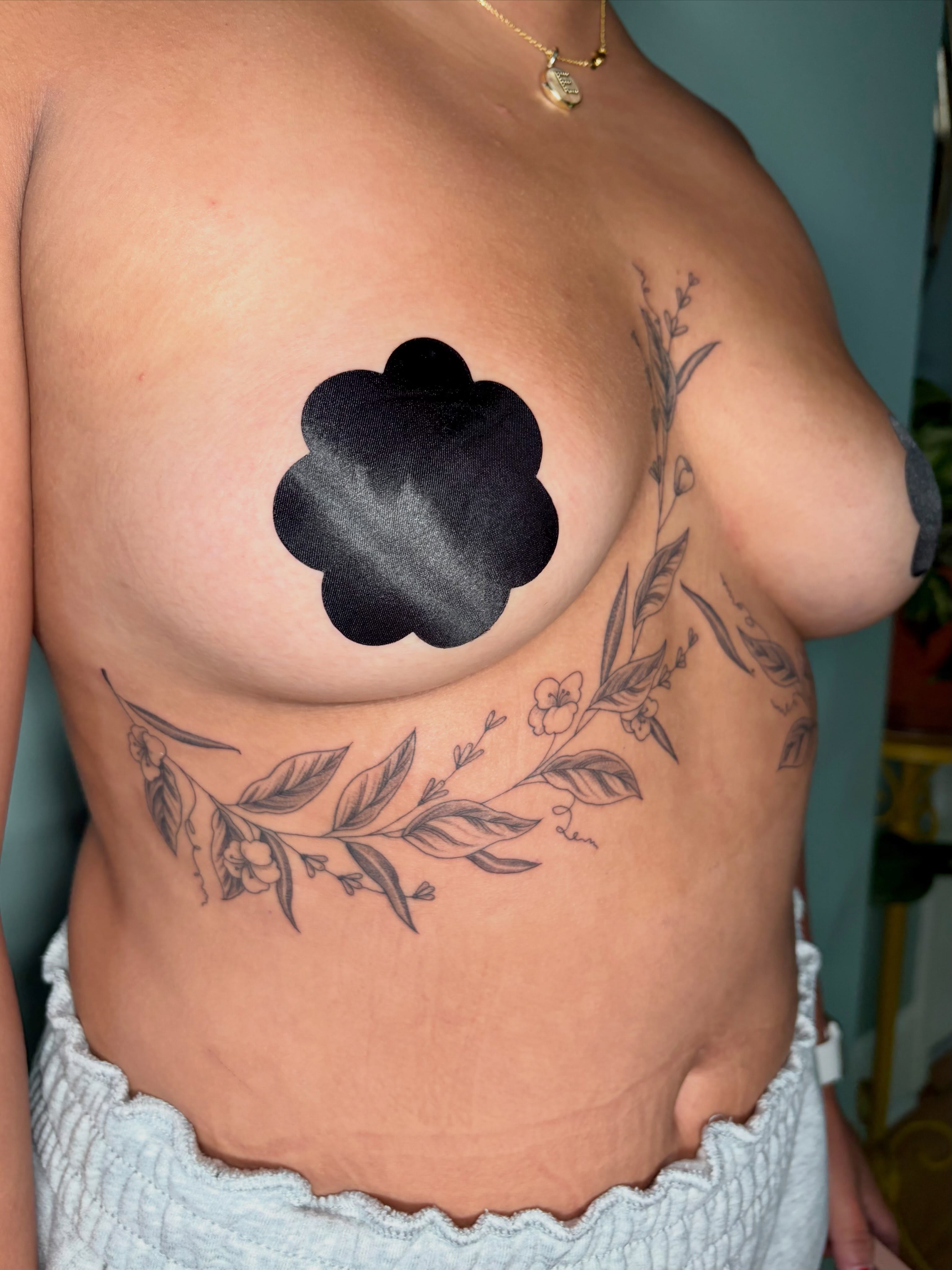Flower black and grey tattoo on the chest by Sarah Roach