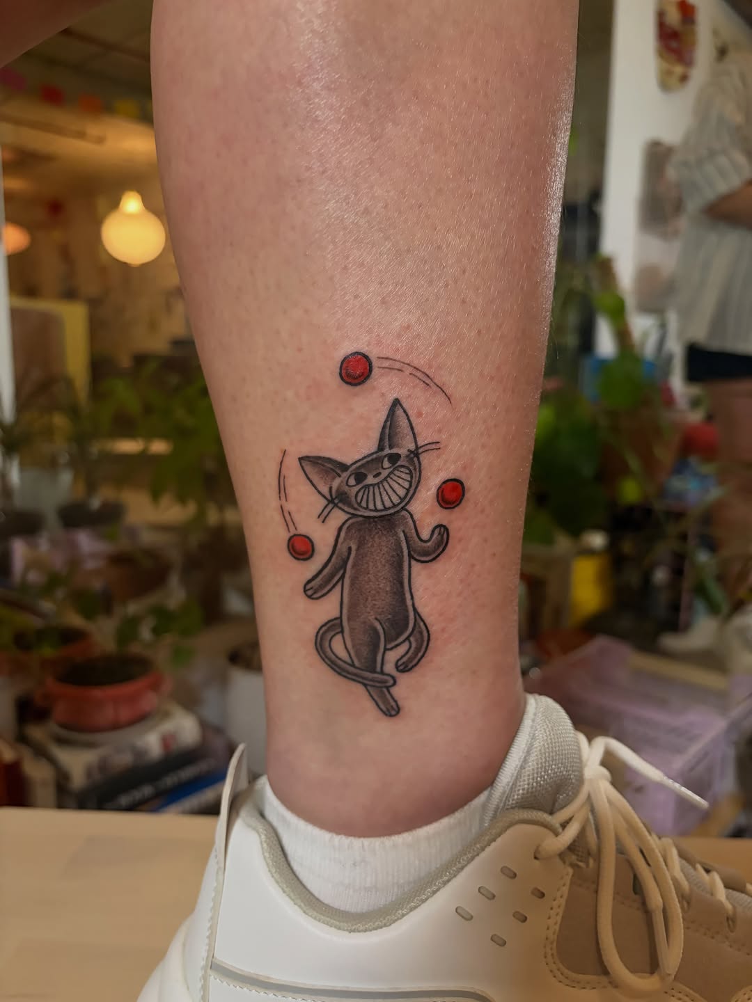 Juggling cat minimalist tattoo on the forearm by Fin :