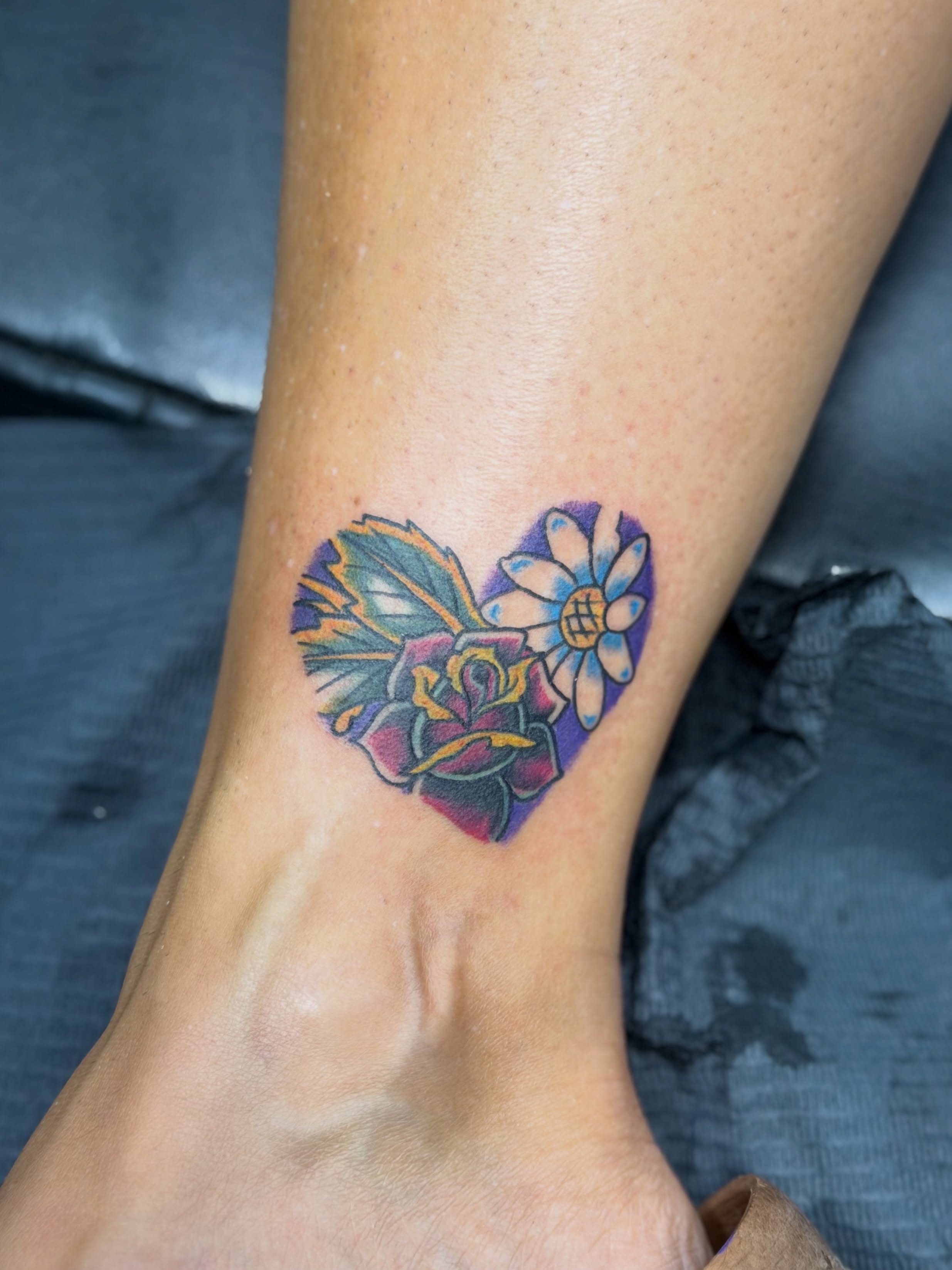 Heart with flowers new school tattoo on the foot by Squid