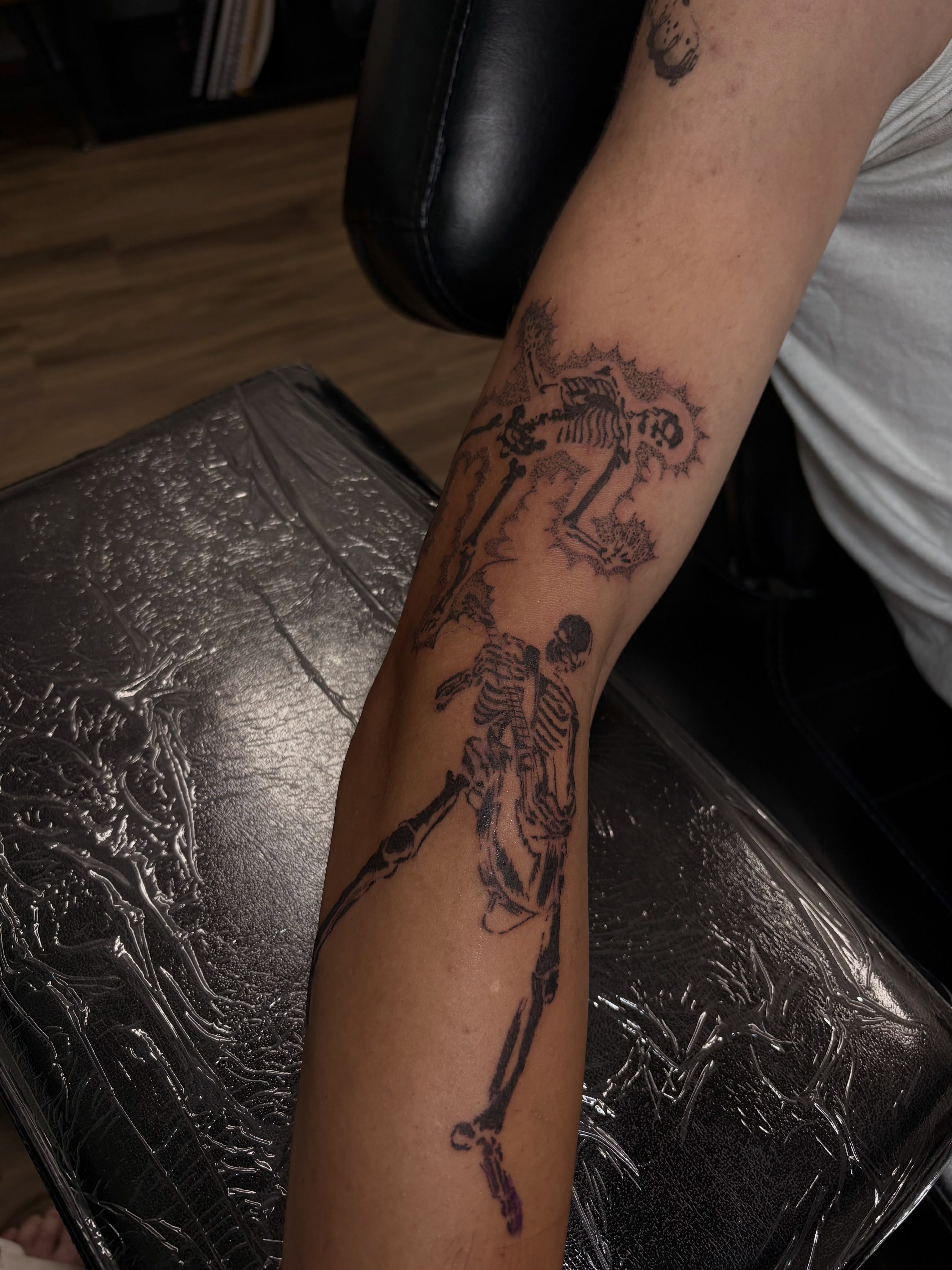 Skeletons black and grey tattoo on the forearm by Cincinnati Tattoo Artist