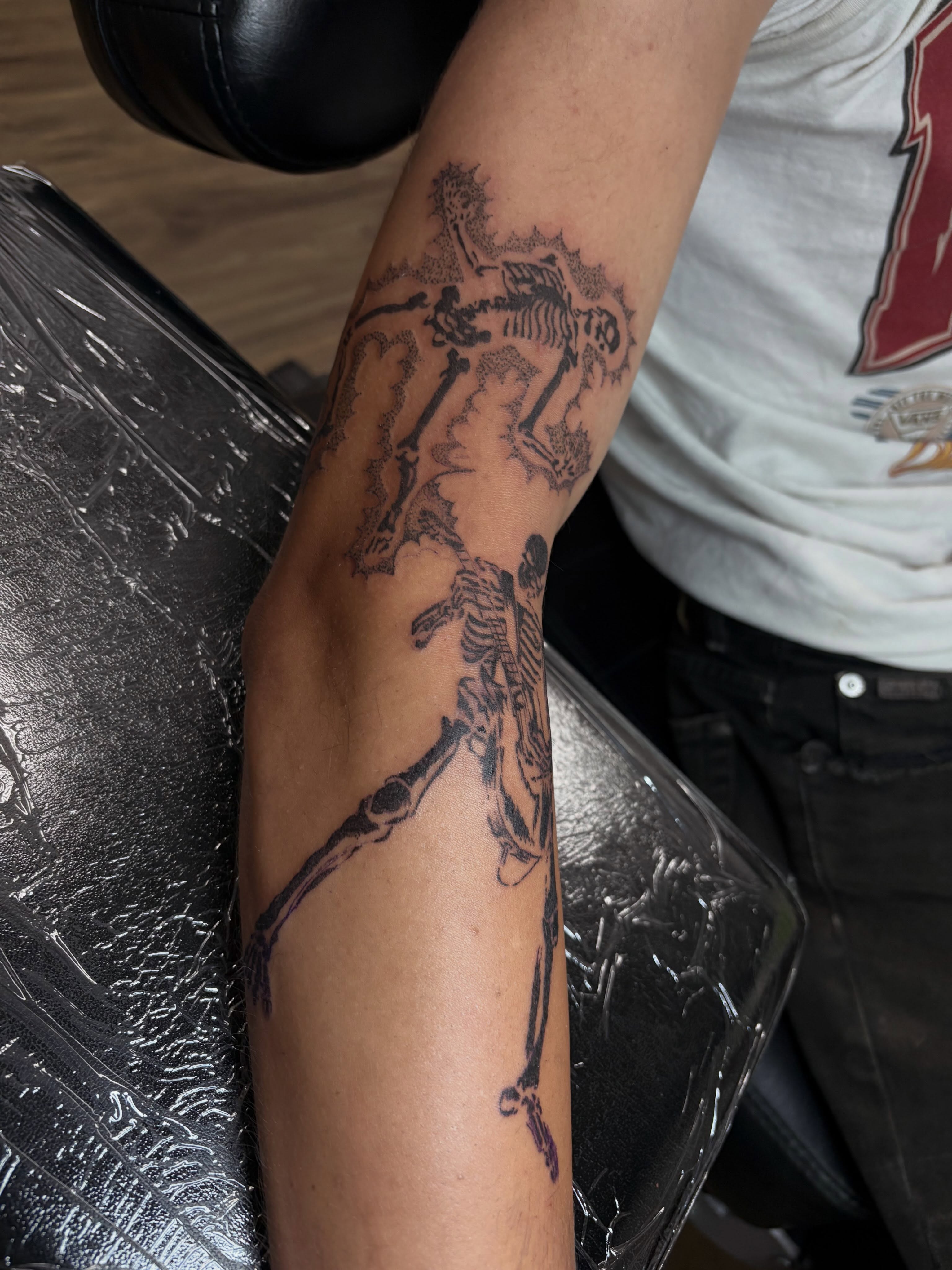 Skeletons black and grey tattoo on the forearm by Cincinnati Tattoo Artist