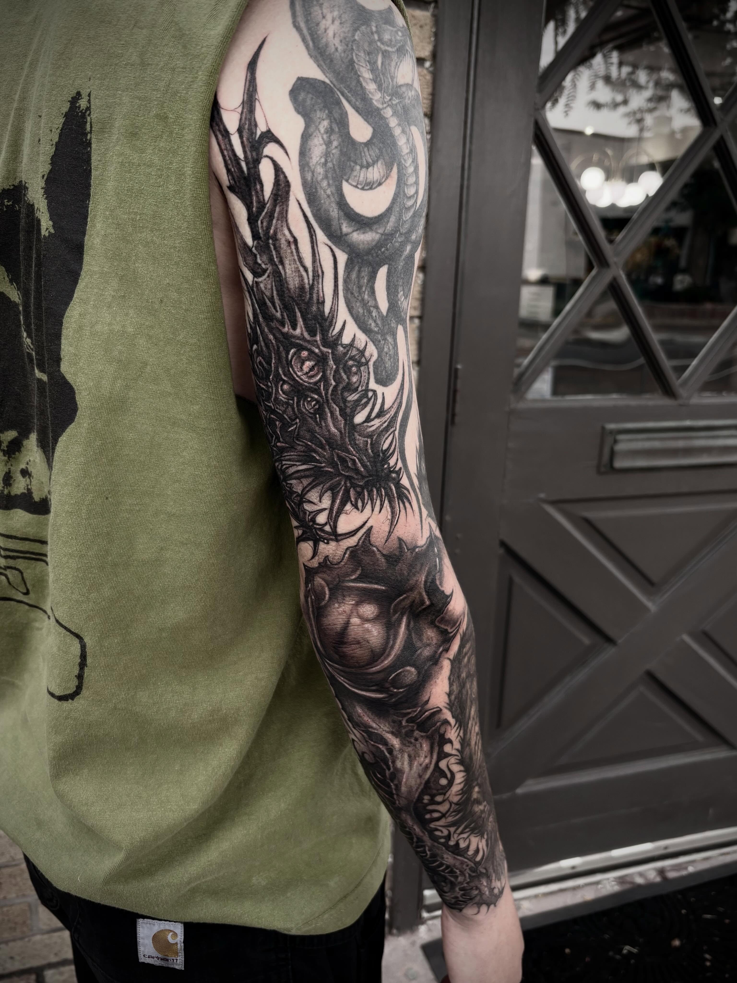 Dragon and snake realism tattoo on the forearm by ๐ท๐๐๐๐
