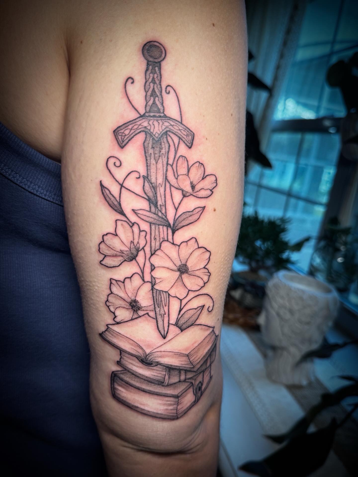 Sword and flowers realism tattoo on the forearm by Tattoos by Alex