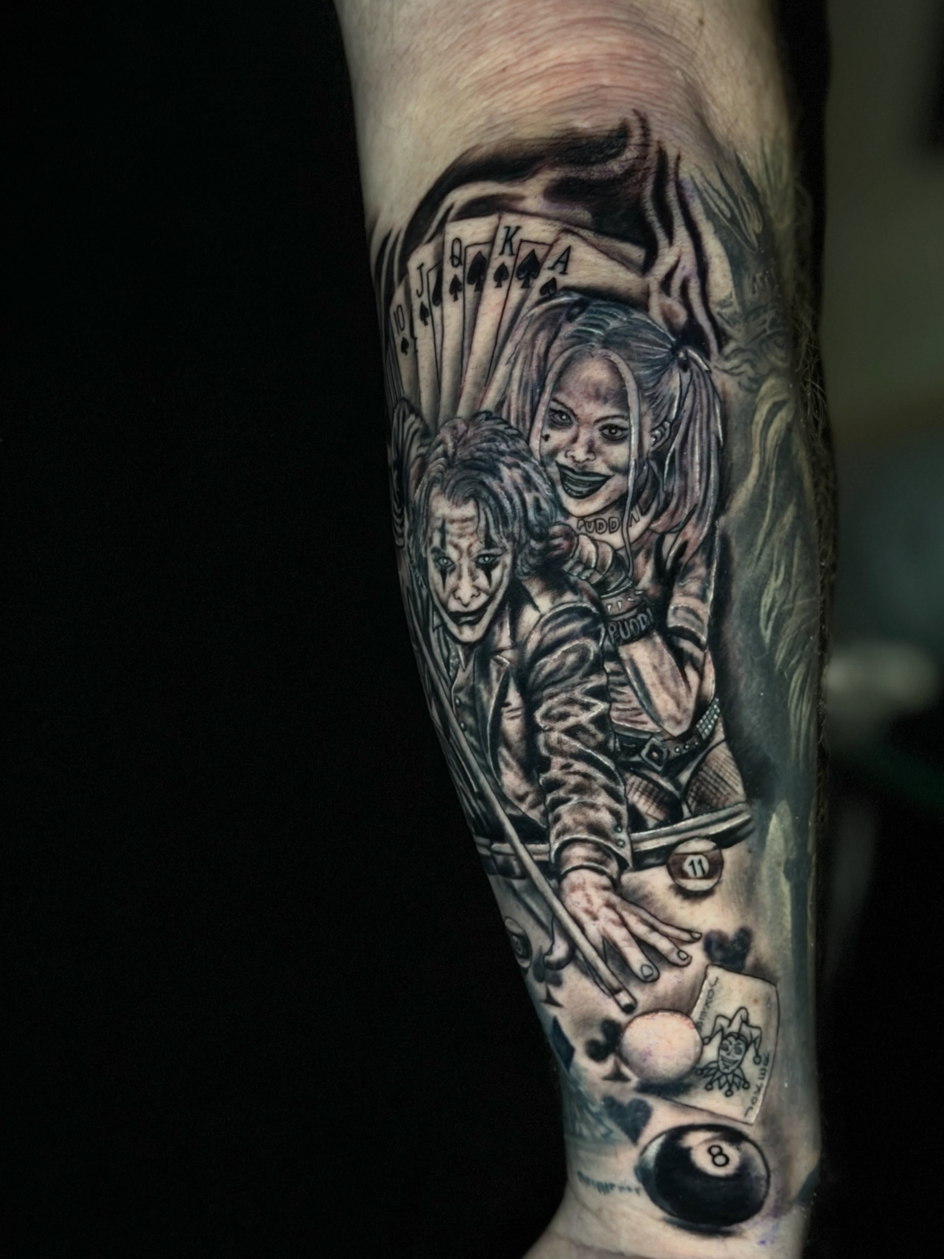 Clowns and playing cards realism tattoo on the forearm by Dany