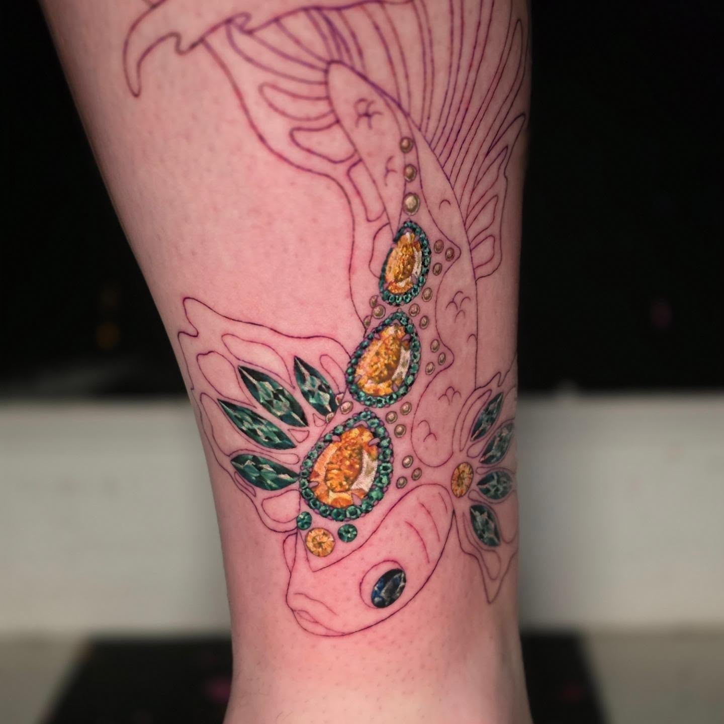 Fish and gemstones geometric tattoo on the forearm by Banana Cake