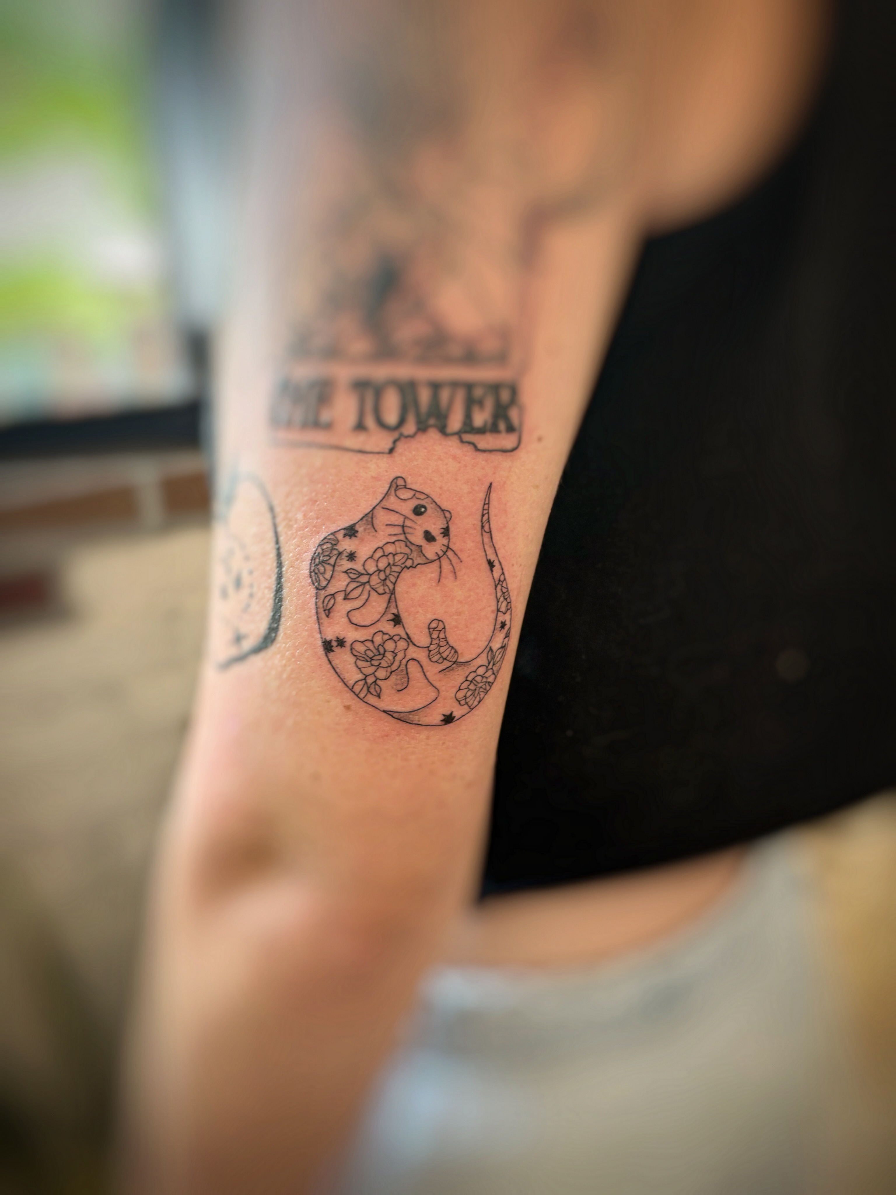 Rat and flowers black and grey tattoo on the forearm by Holly
