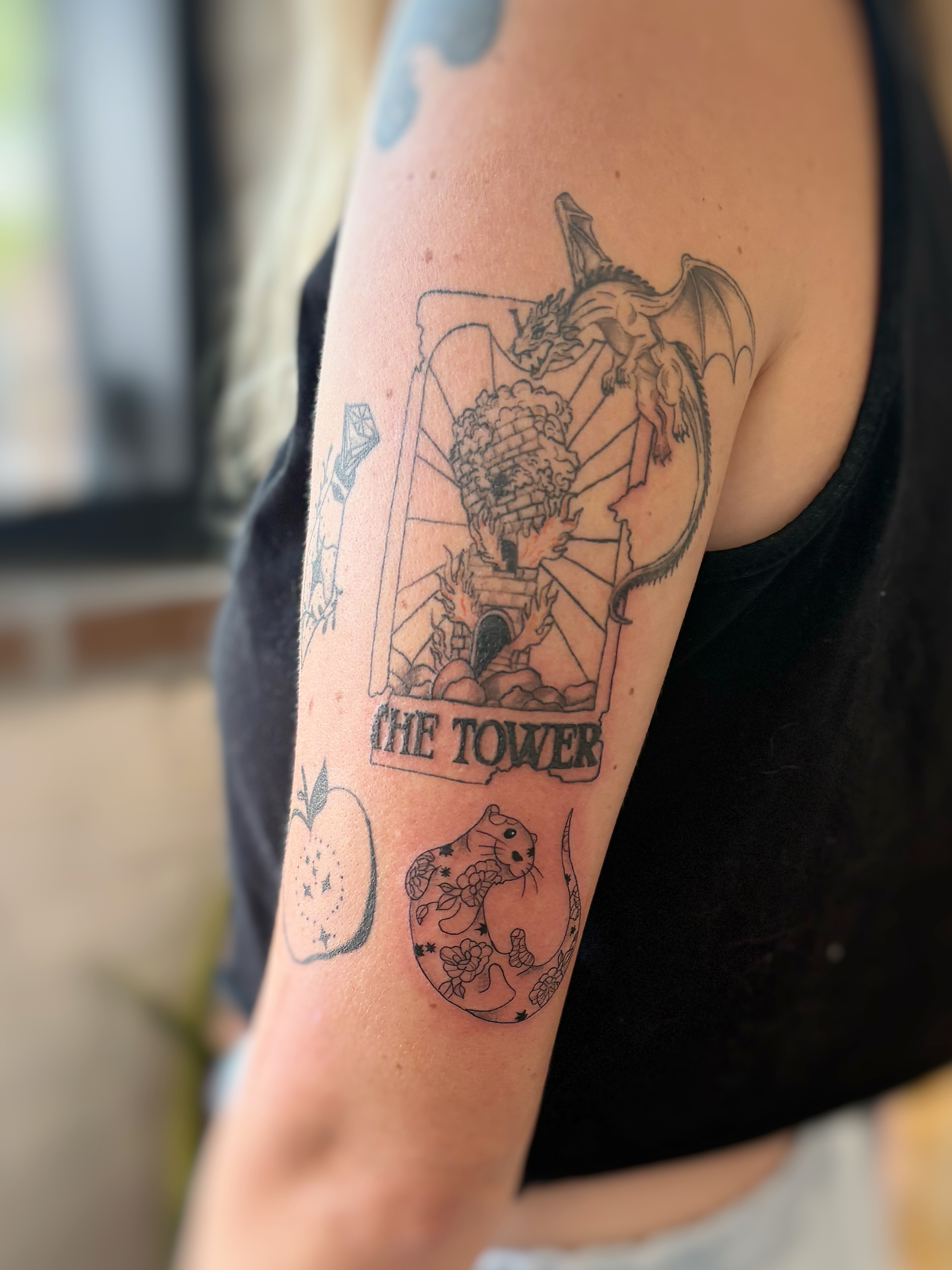 The tower tarot card black and grey tattoo on the forearm by Holly