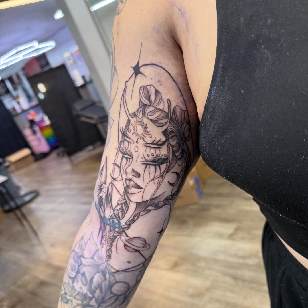 Woman with celestial elements realism tattoo on the forearm by Jordan Clifford