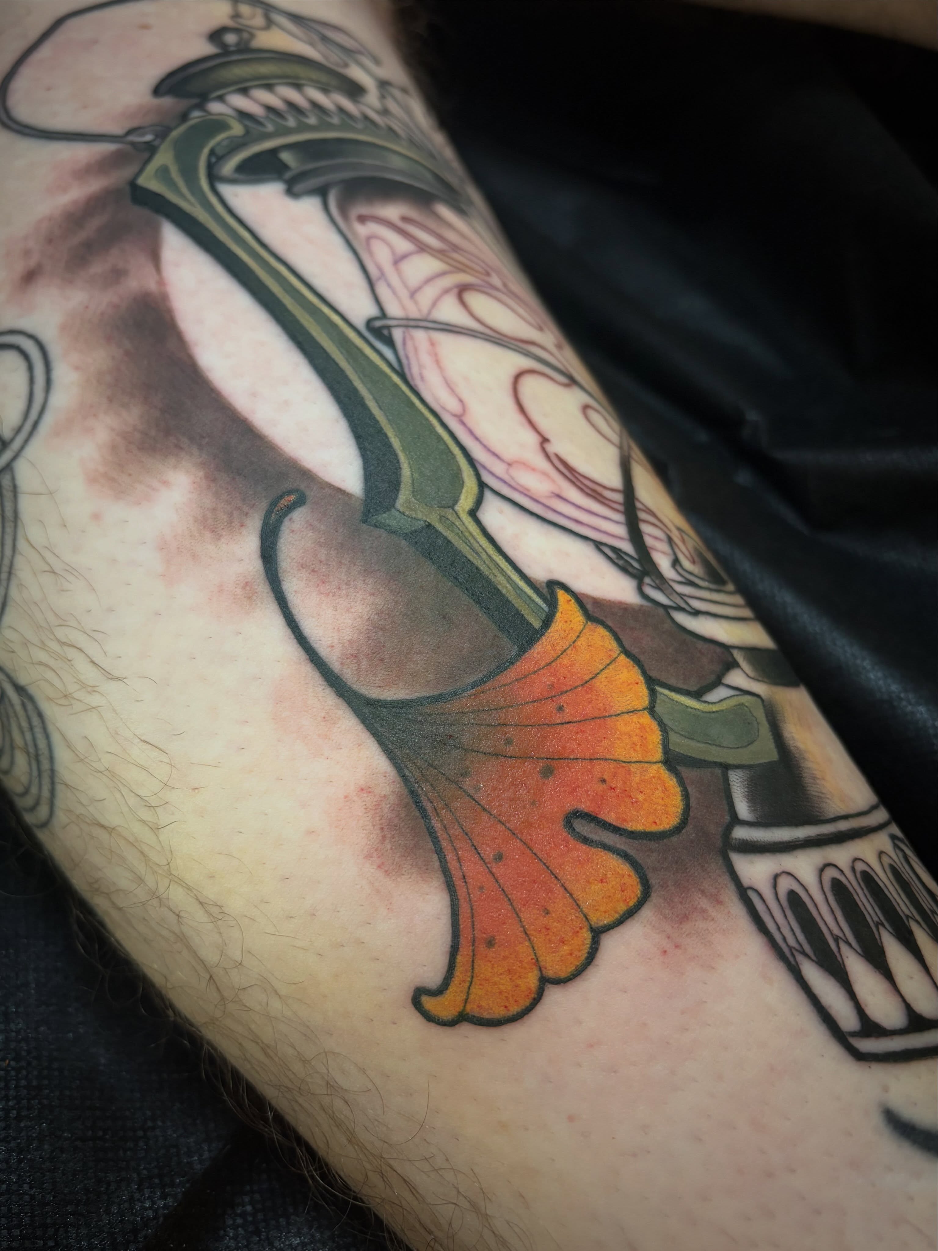 Knife and leaf American traditional tattoo on the forearm by Alex