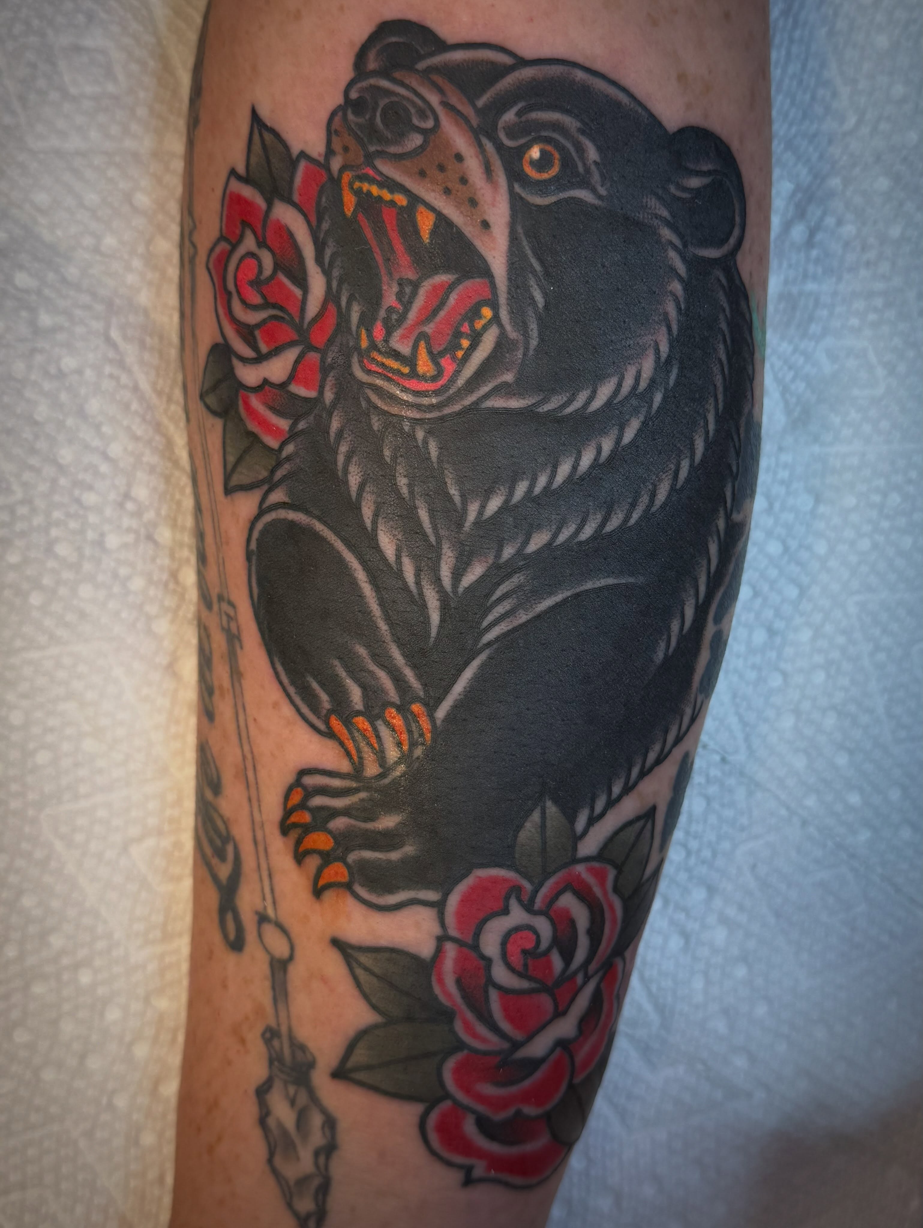 Bear and roses American traditional tattoo on the forearm by Jason Lawyer