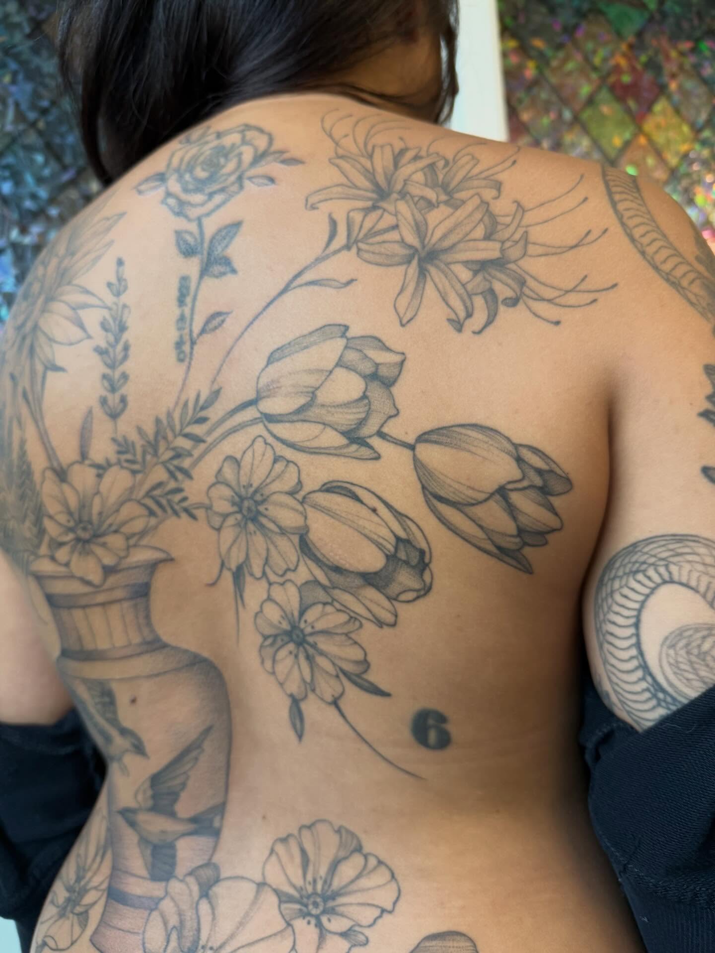 Floral bouquet realism tattoo on the back by Peter Harren