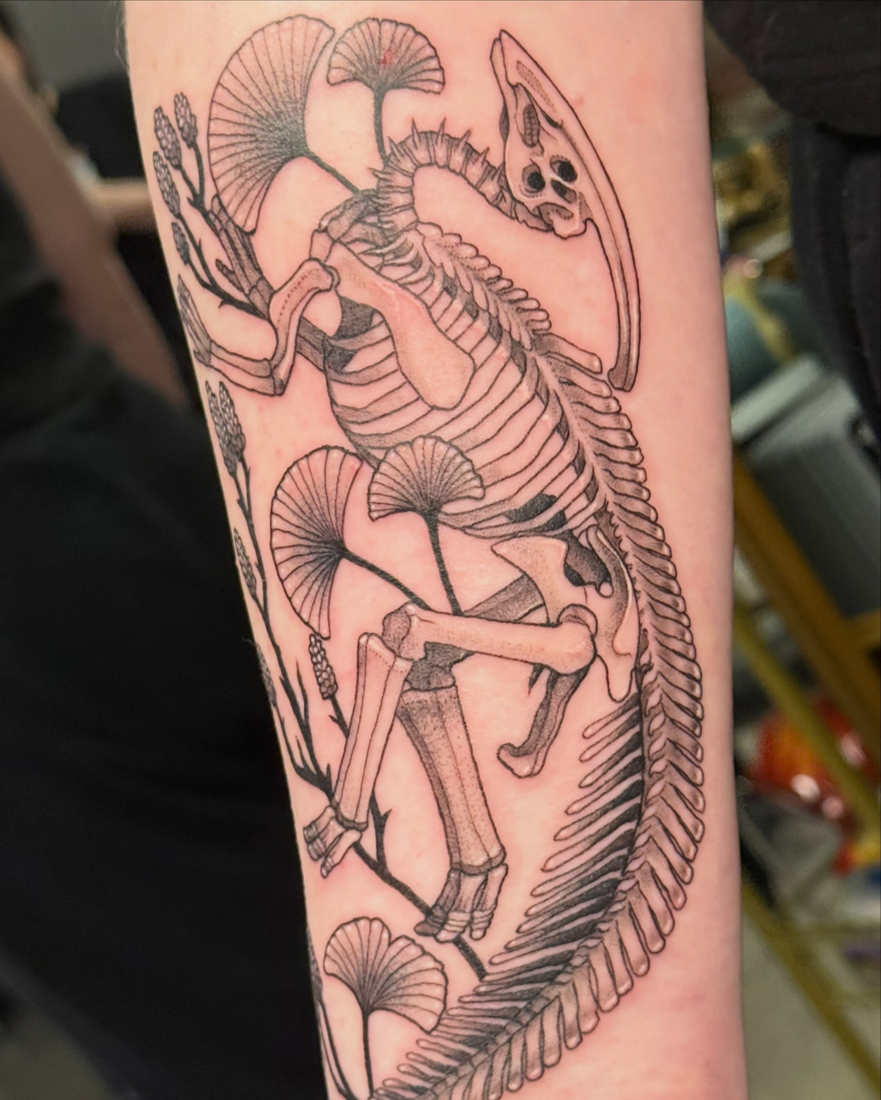 Skeleton with flora realism tattoo on the forearm by Christian