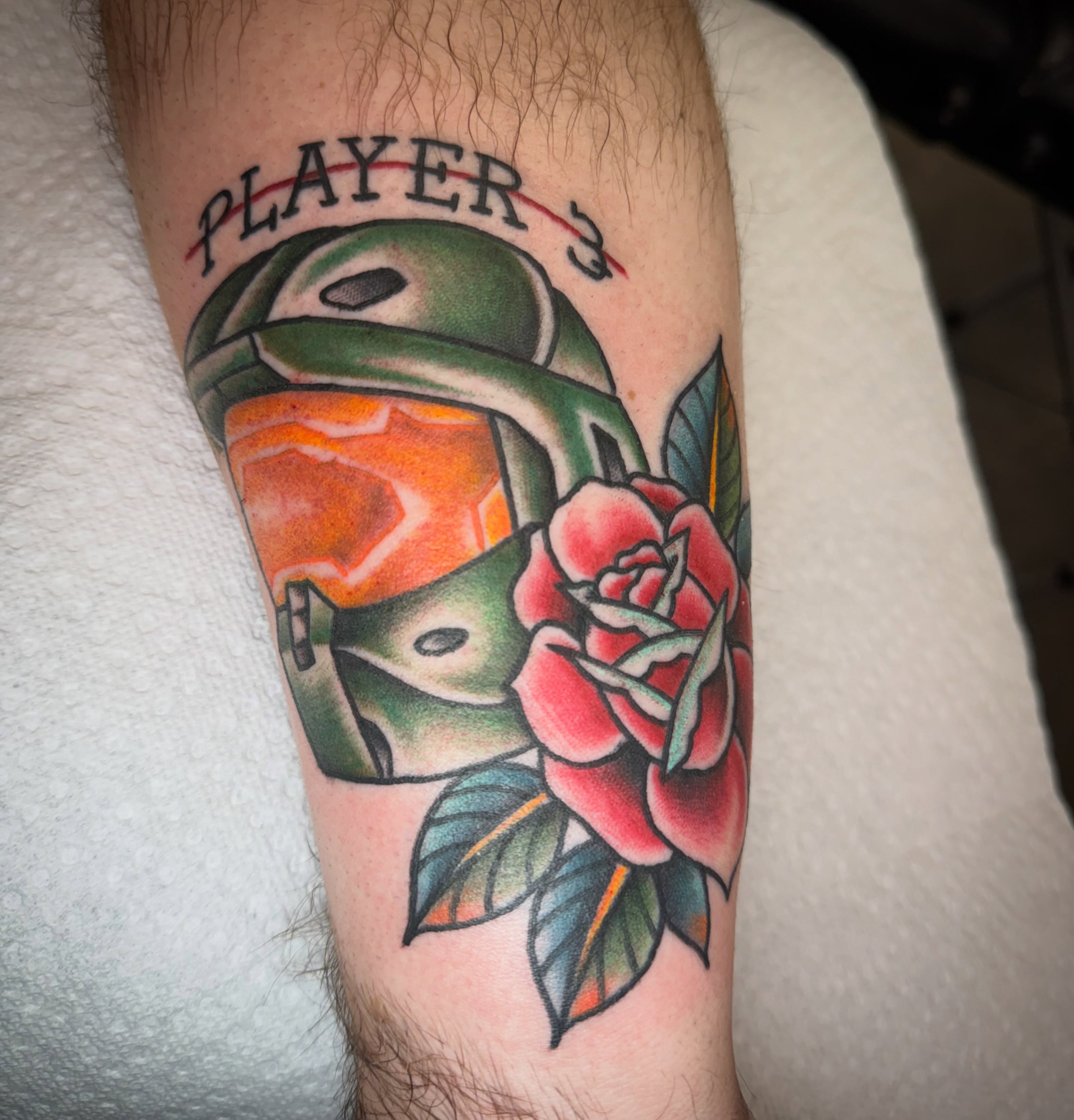 Boba Fett helmet and rose American traditional tattoo on the forearm by Jake Horstman, Dayton, Ohio