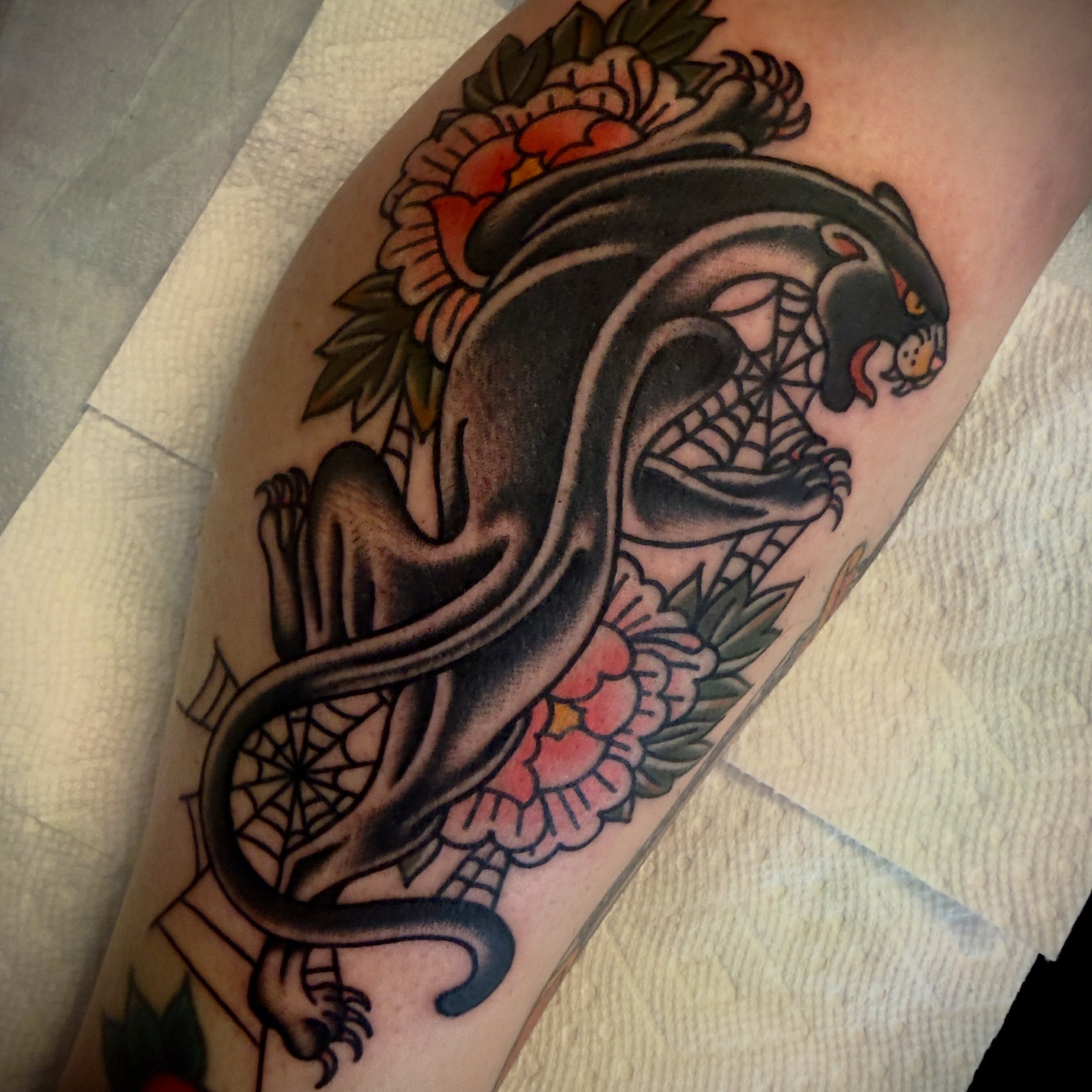 Panther and flowers American traditional tattoo on the forearm by Andrew Slater