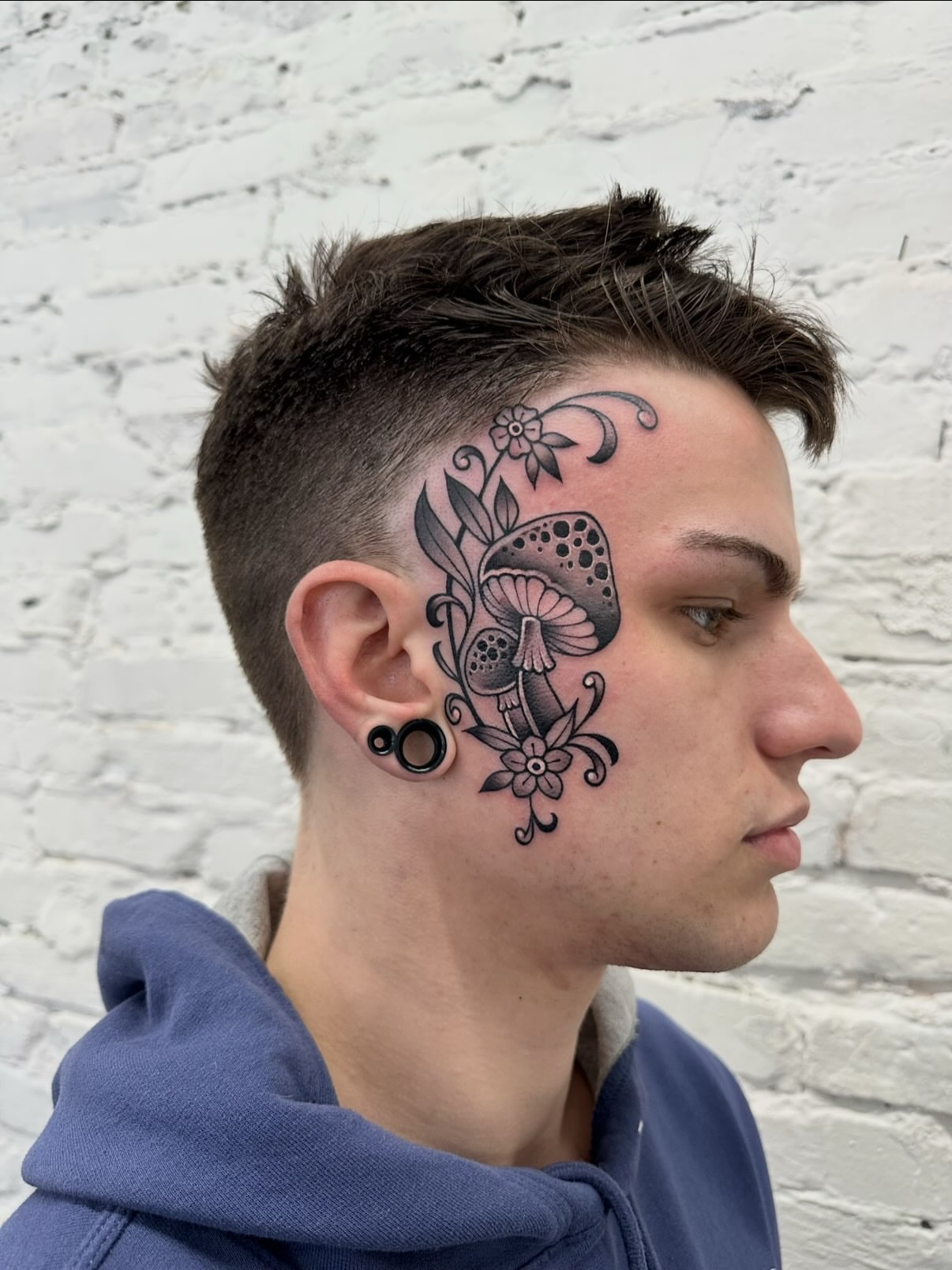 Mushroom and floral black and grey tattoo on the head by Mark Boller