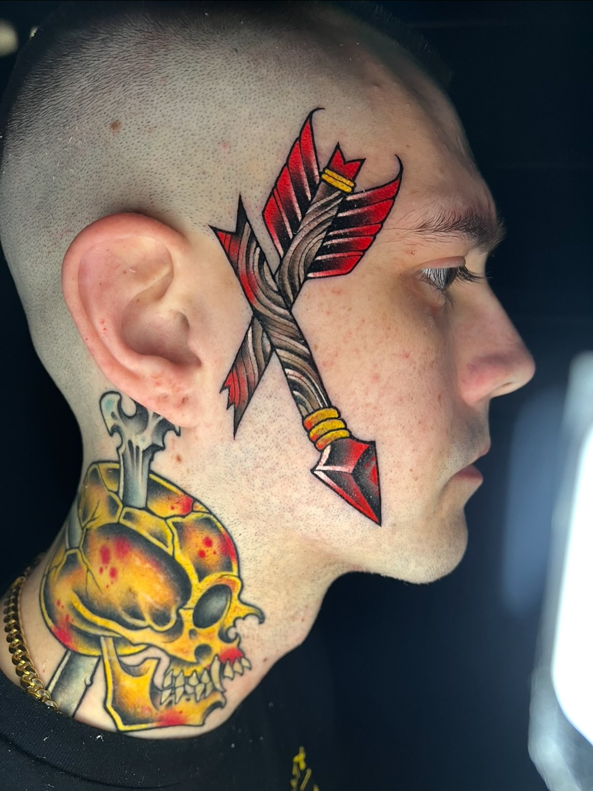 Arrow and skull American traditional tattoo on the neck by Mark Boller