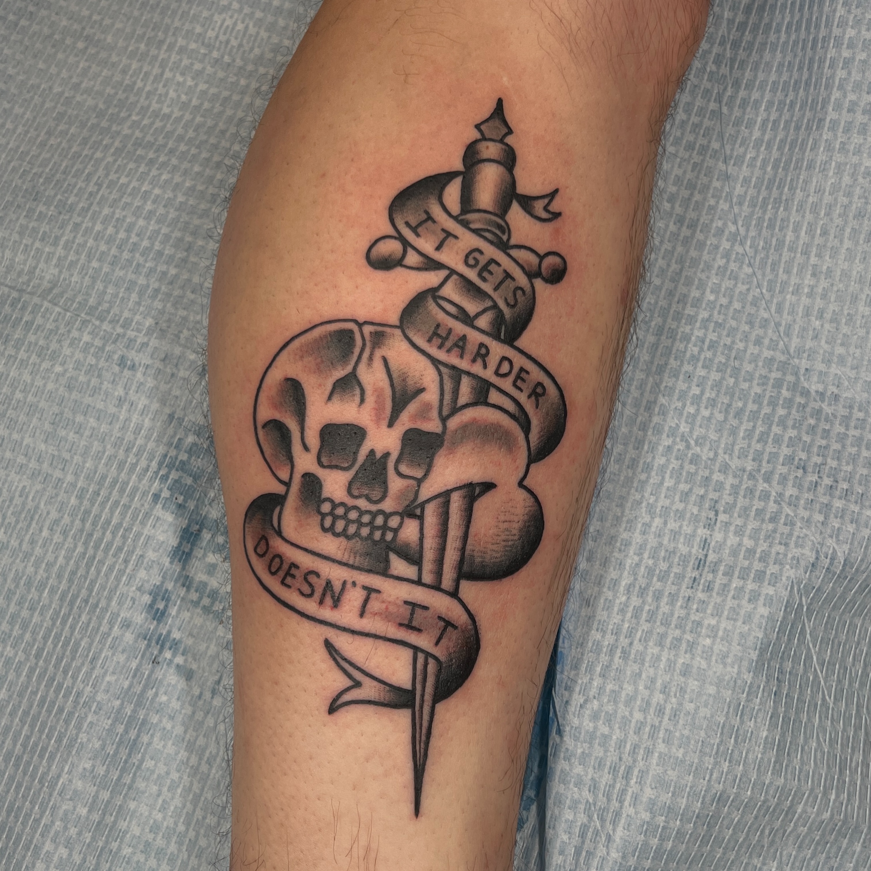 Skull and dagger black and grey tattoo on the forearm by Brian Mock