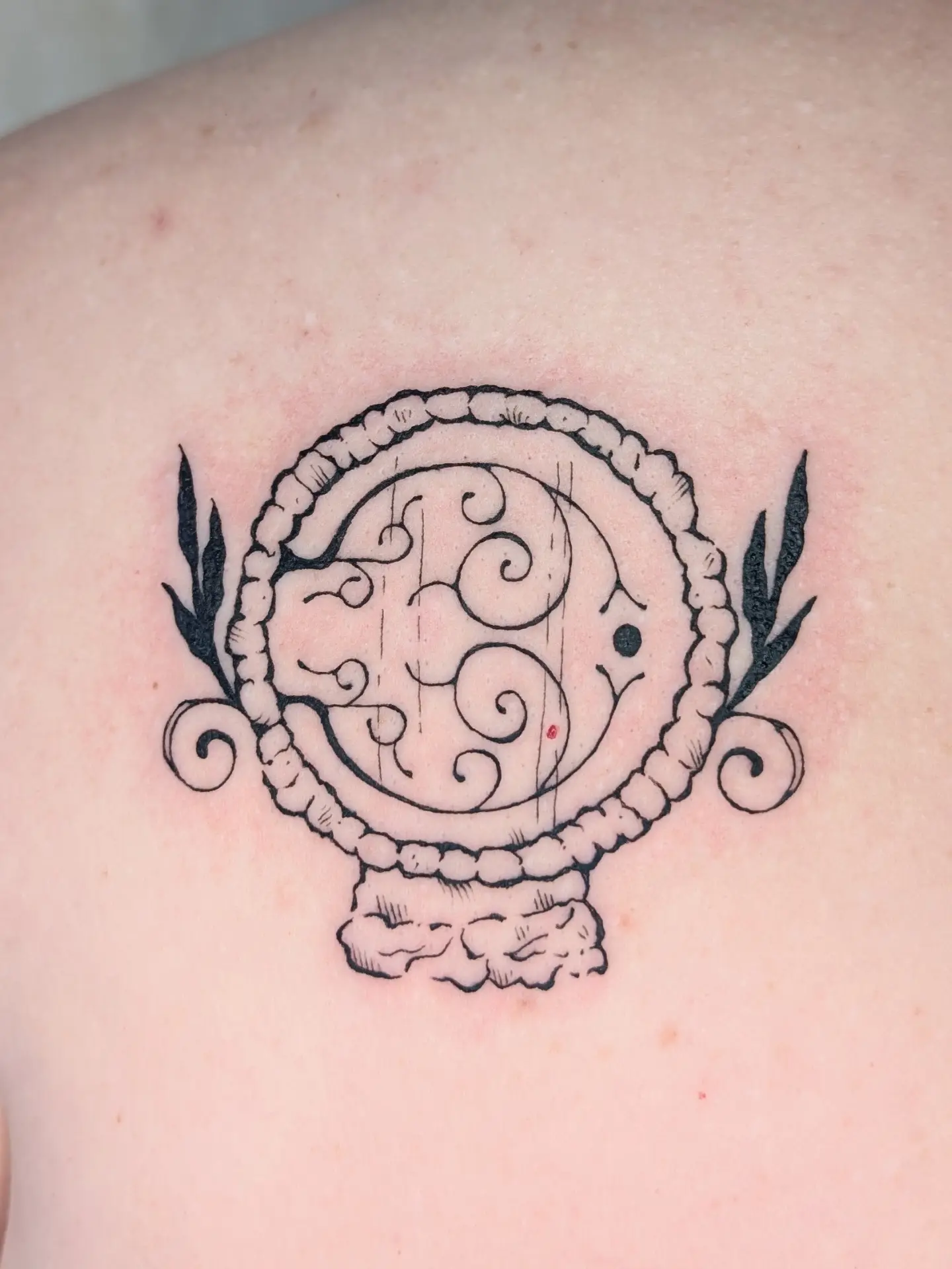 Triskele neo-traditional tattoo on the shoulder by mila