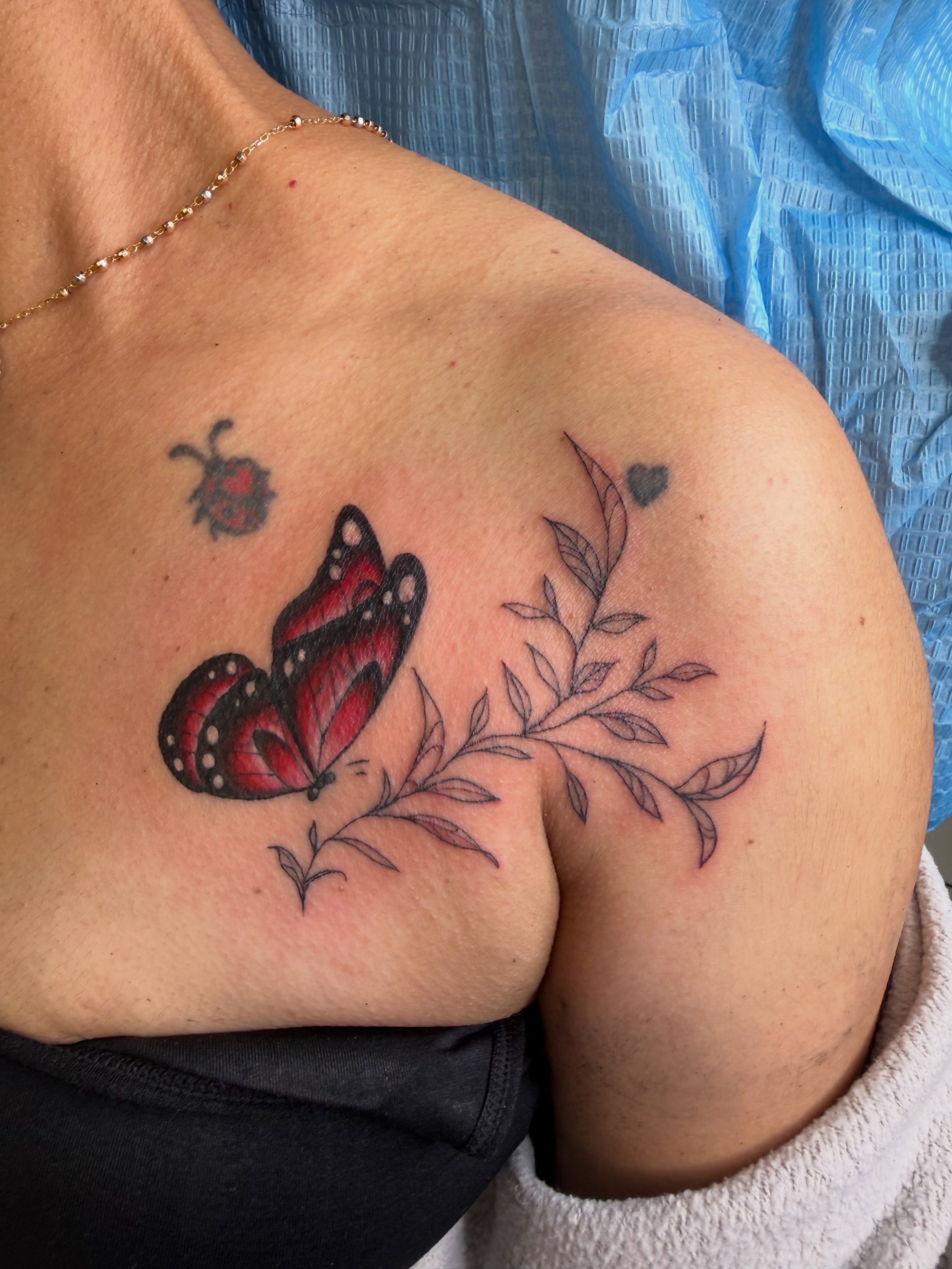 Butterfly and leaf dotwork tattoo on the shoulder by linda perez