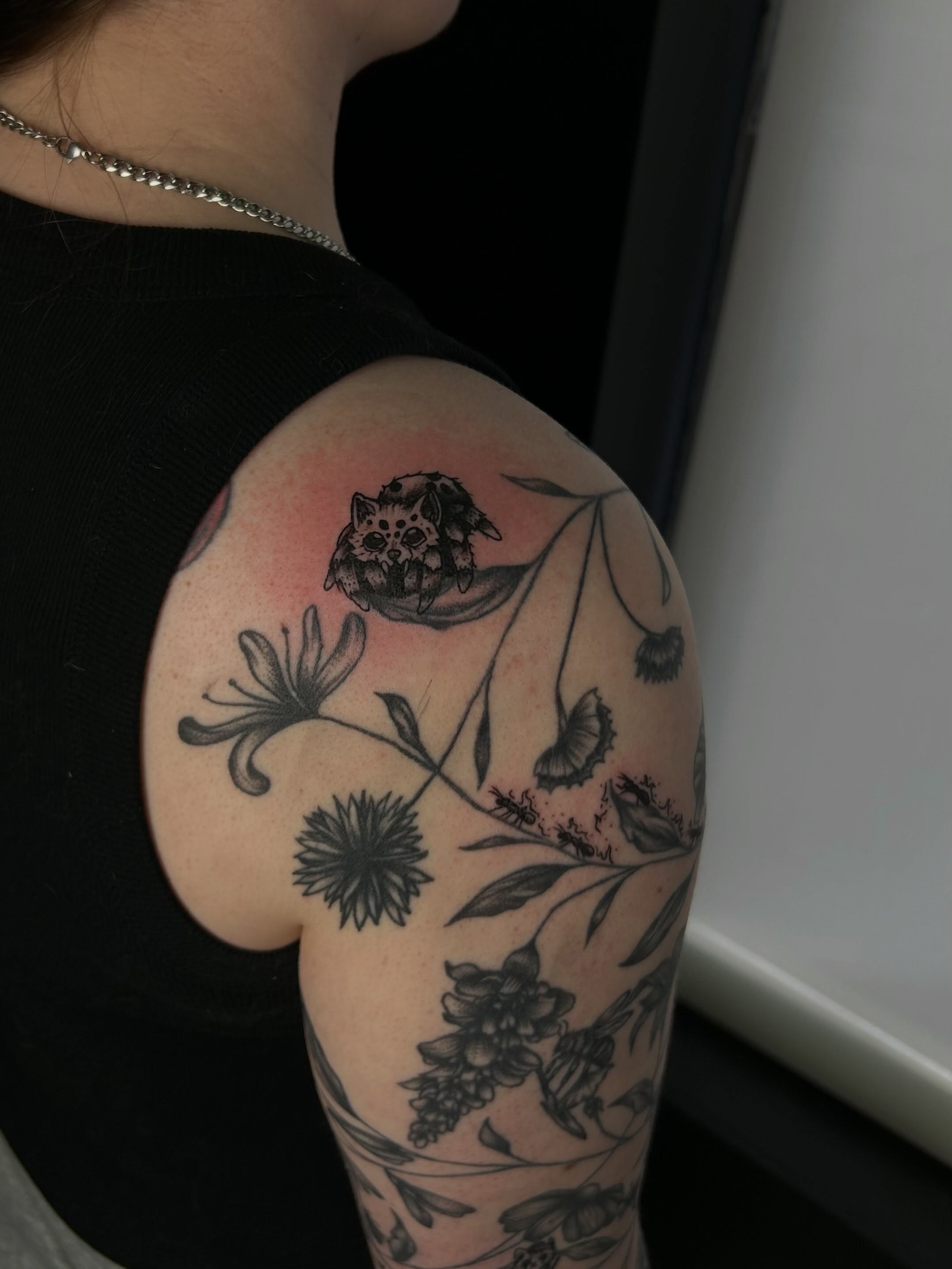 Cat and floral black and grey tattoo on the shoulder by Kenadee