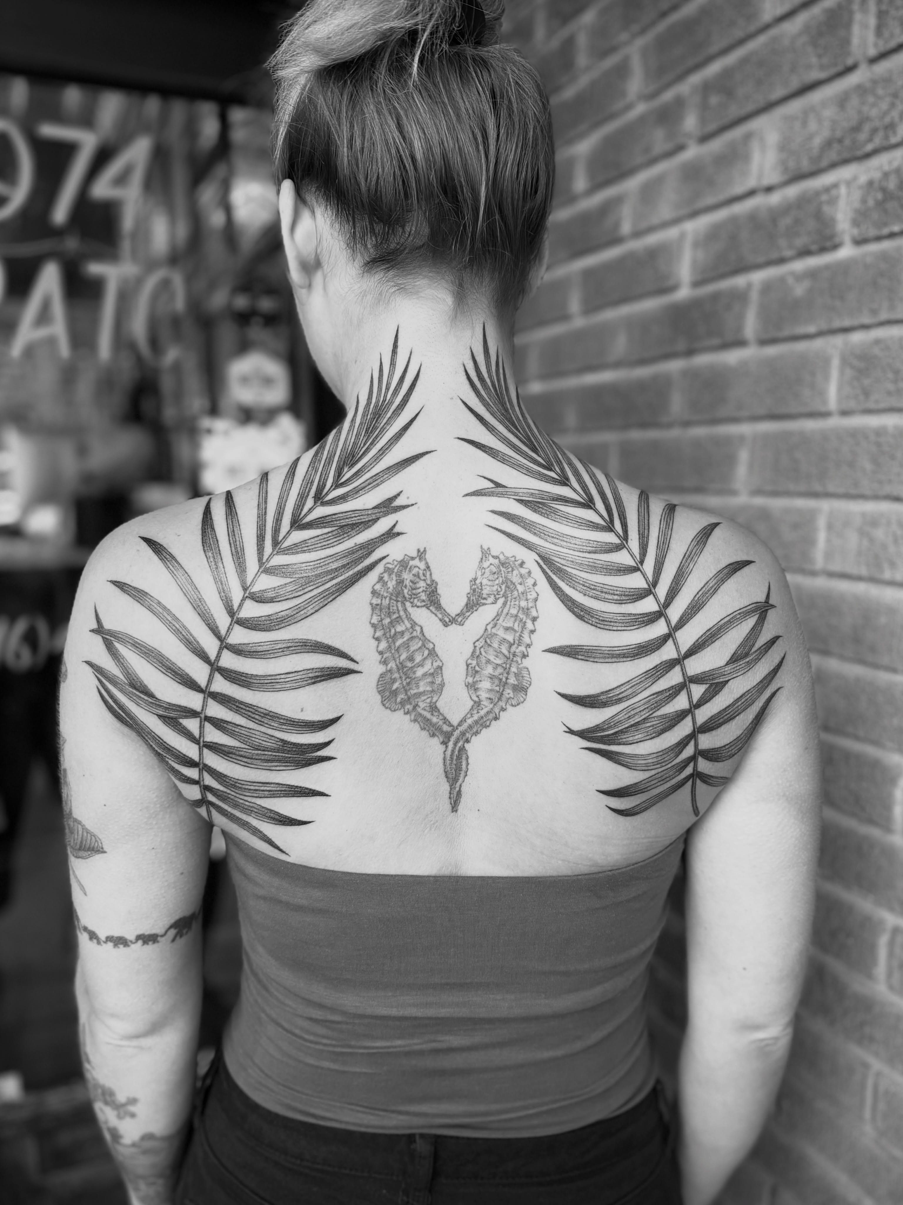 Seahorses black and grey tattoo on the back by Alex Brooke