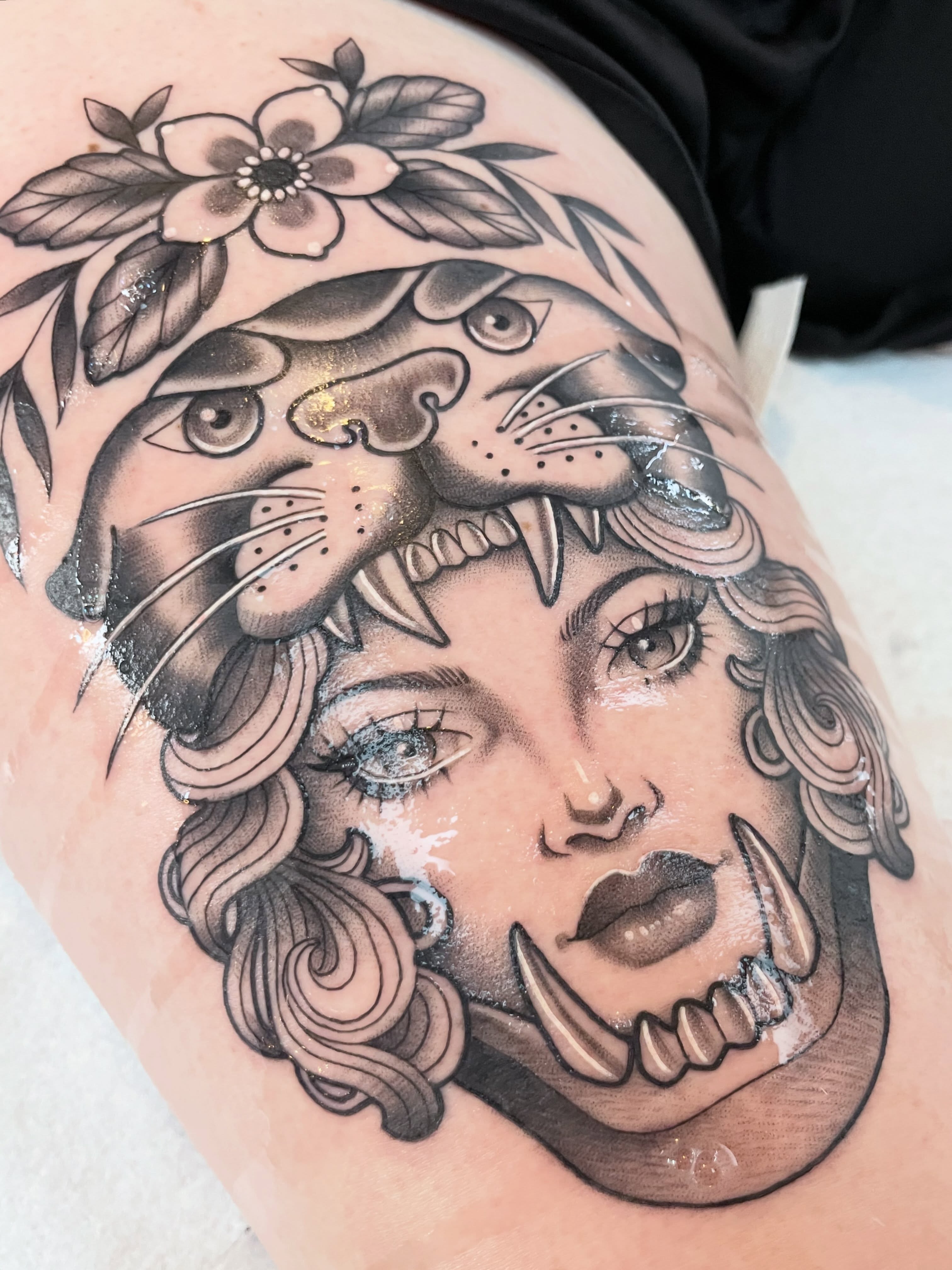 Woman with tiger American traditional tattoo on the thigh by ✨Erin Haines✨