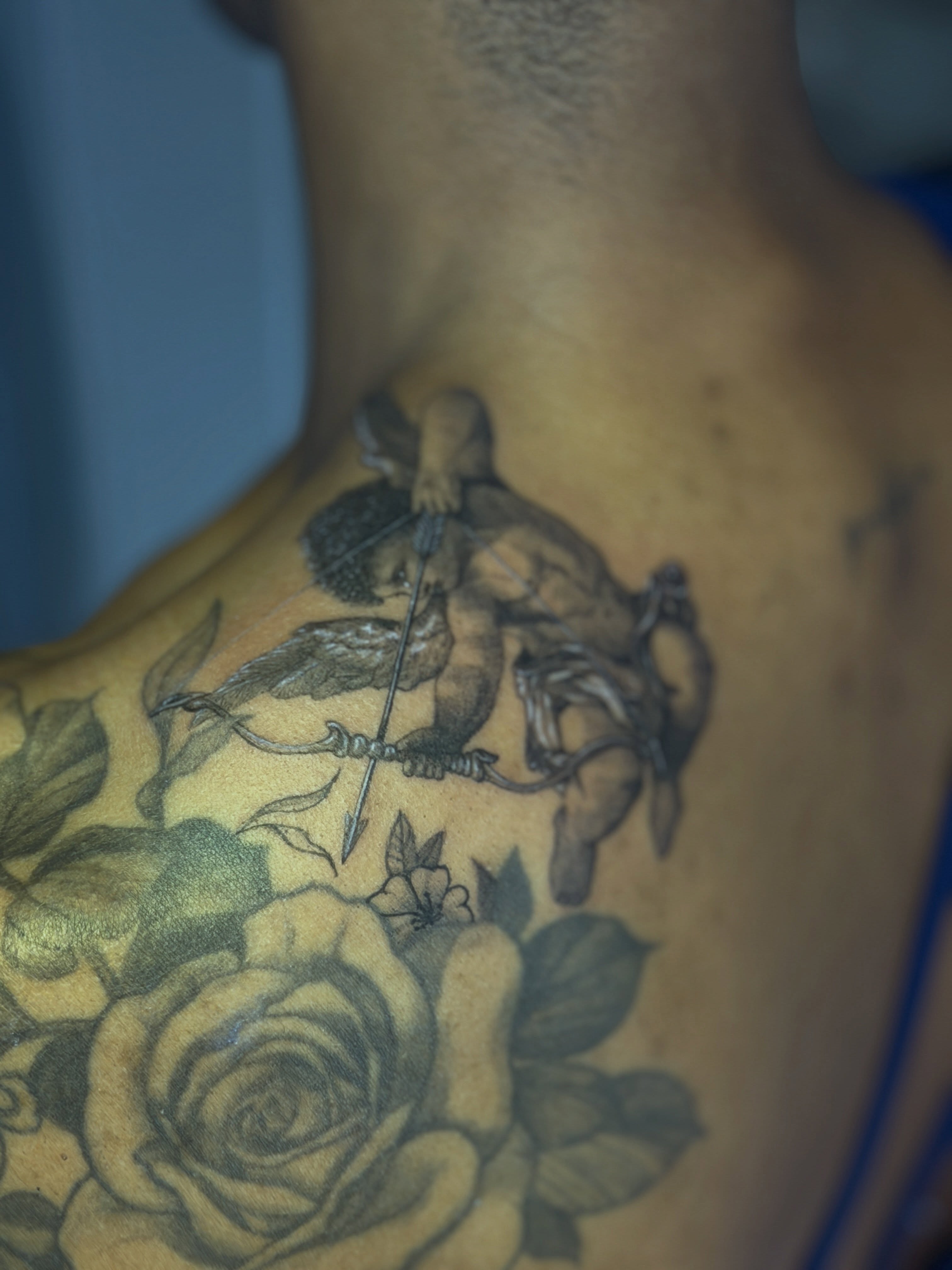 Archer and roses realism tattoo on the chest by Raciel Fabian Romero