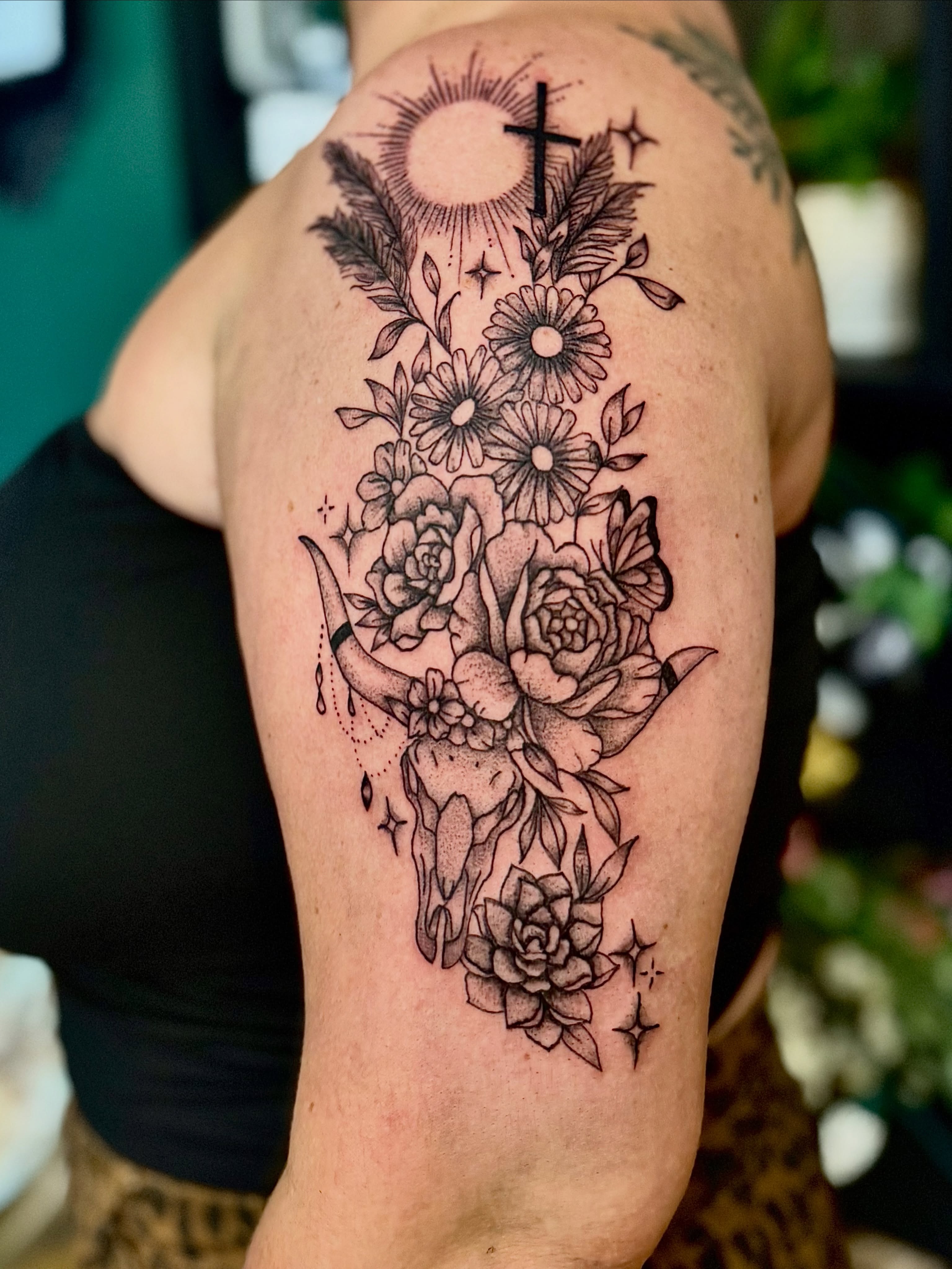 Floral bouquet with skull neo-traditional tattoo on the shoulder by Haley Bates