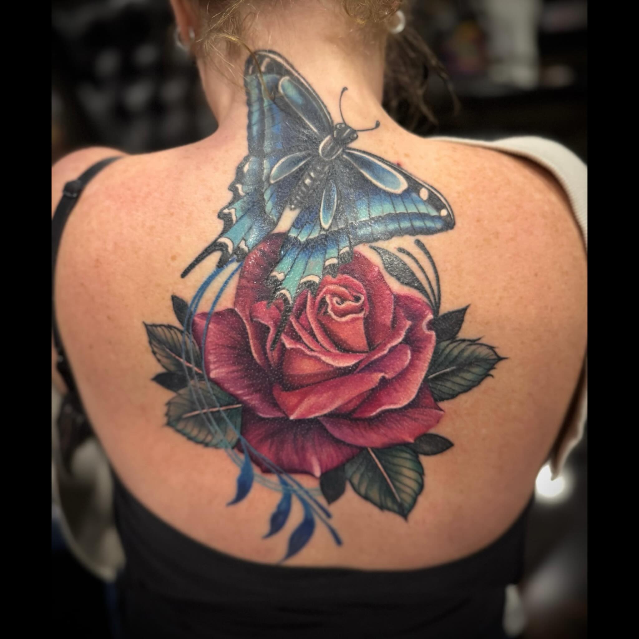 Rose and butterfly realism tattoo on the back by Shae Sullivan
