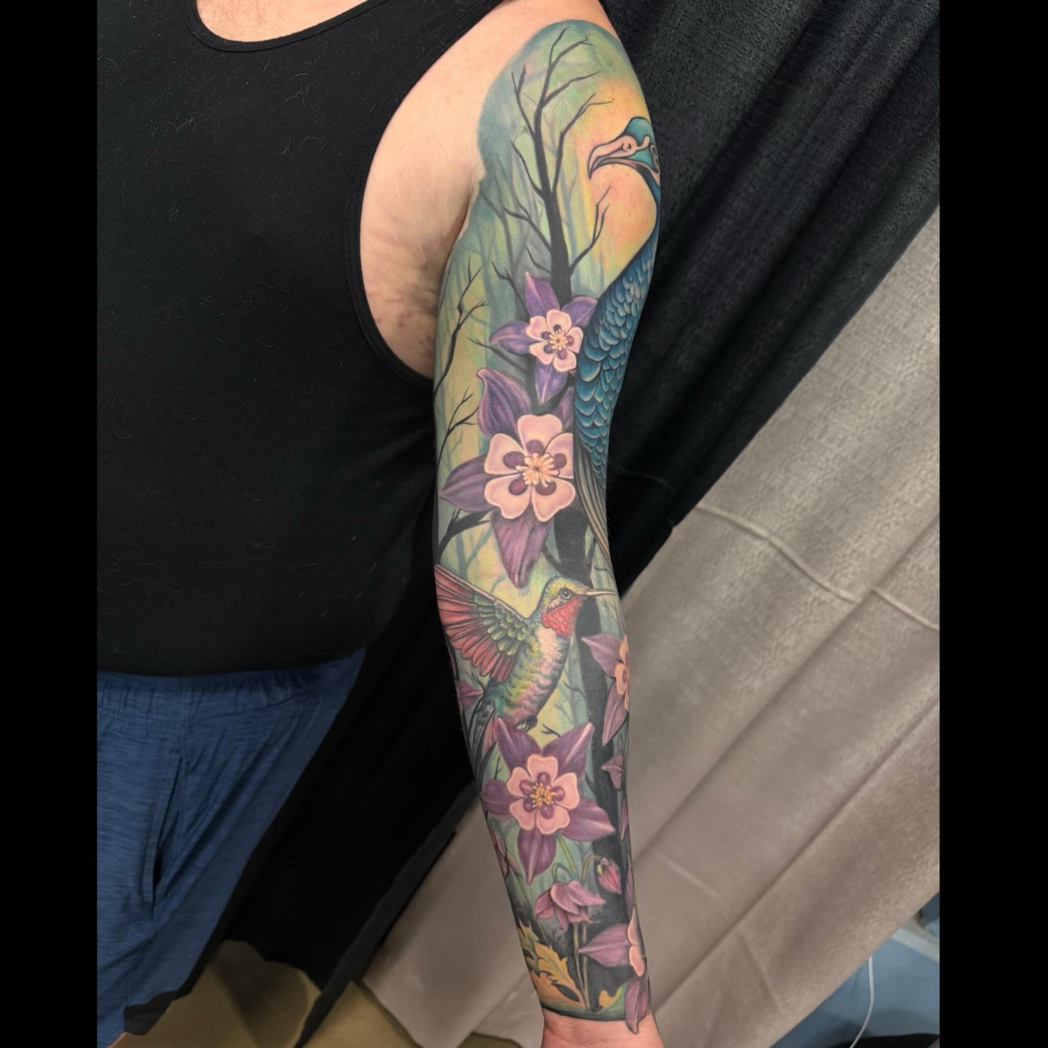 Bird and flowers new school tattoo on the forearm by Shae Sullivan