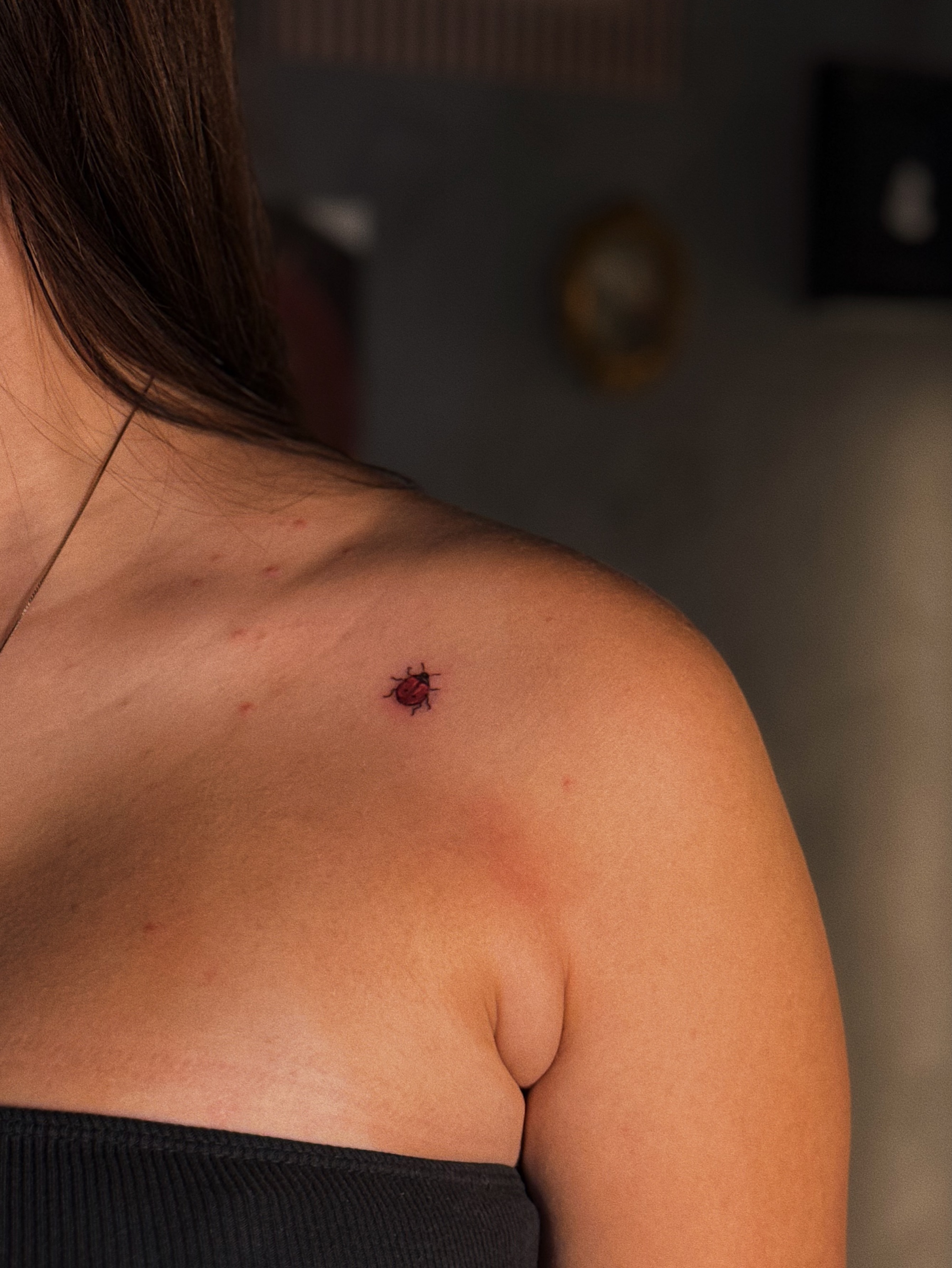 Ladybug dotwork tattoo on the shoulder by Luisa Duarte