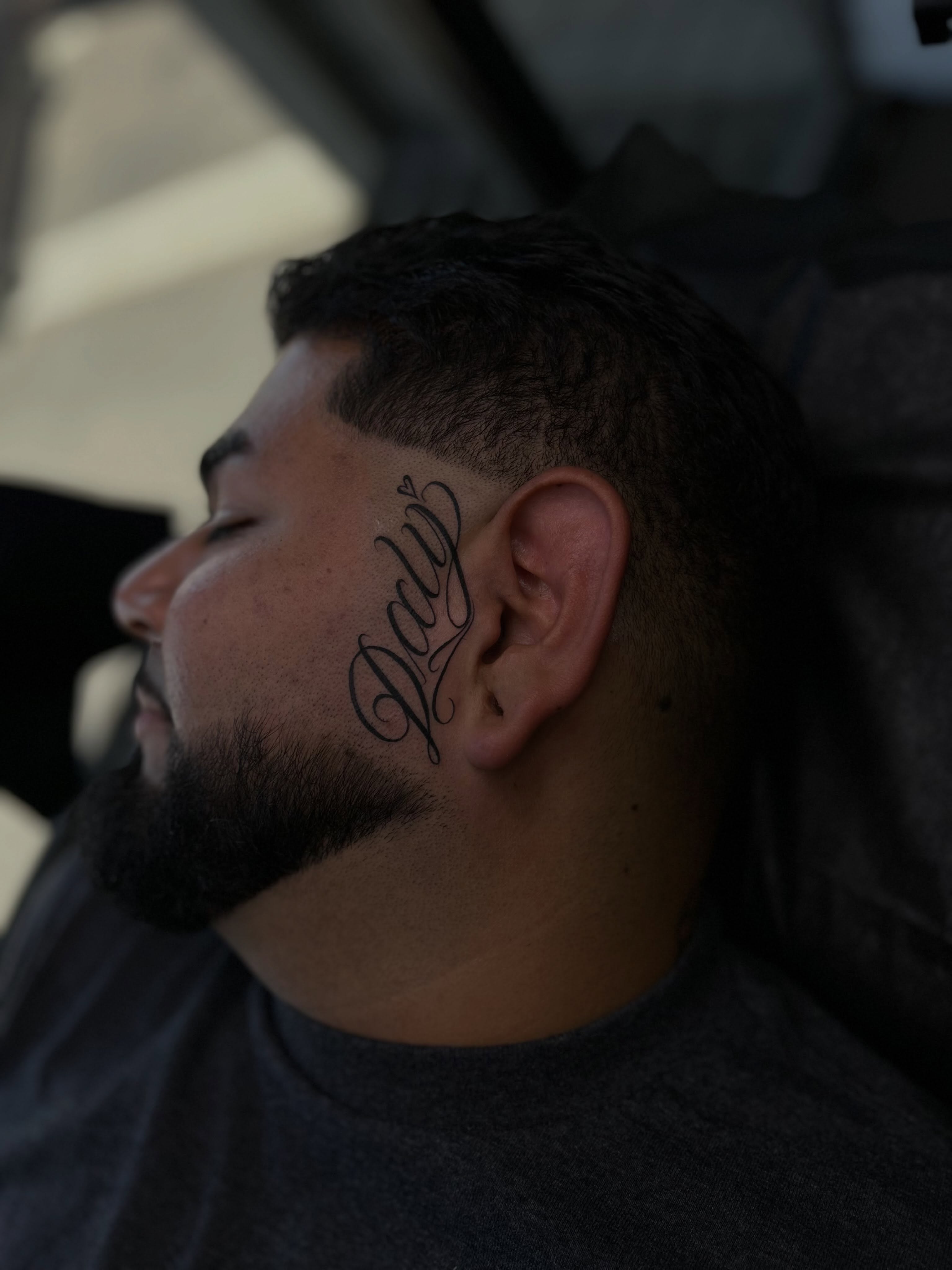 Script lettering lettering script tattoo on the head by Tattoo Artist