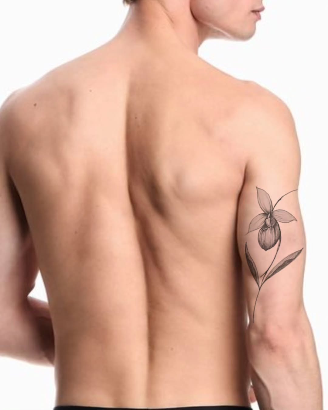 Orchid black and grey tattoo on the upper arm by Tattoo artist - Luciana Dsilva, San Francisco, California