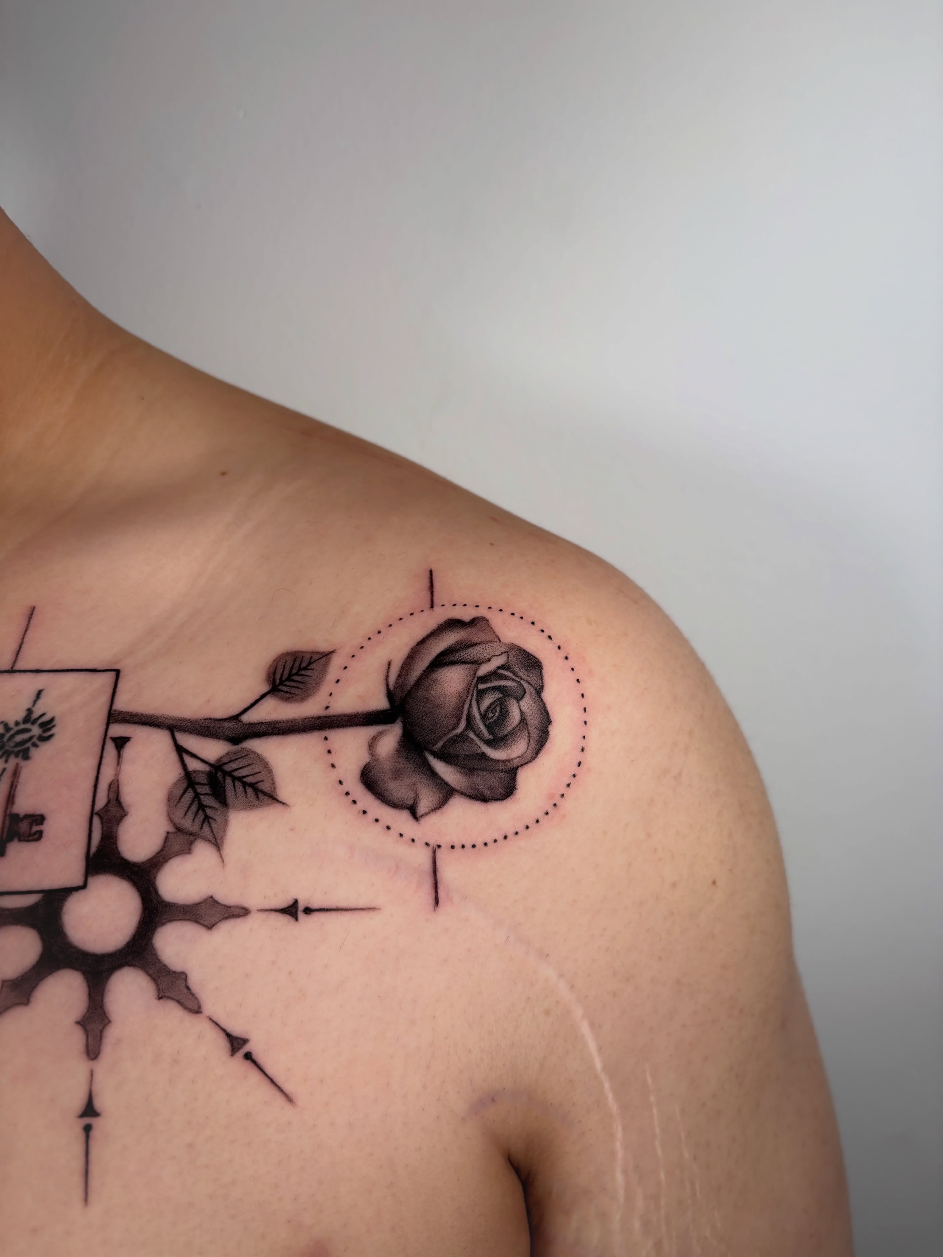 Rose black and grey tattoo on the shoulder by Dani