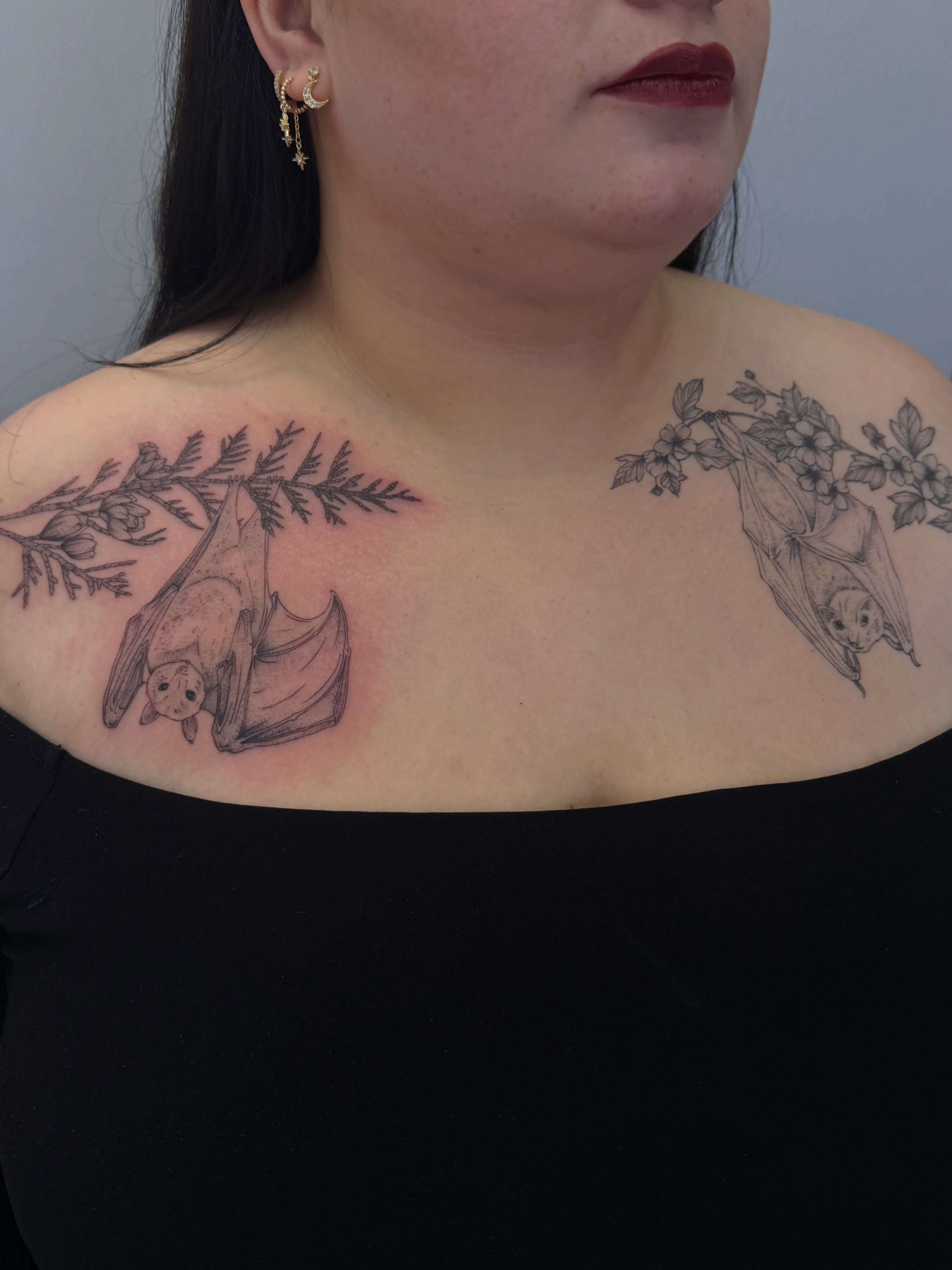Bat and floral branch black and grey tattoo on the chest by Henesee Parfitt