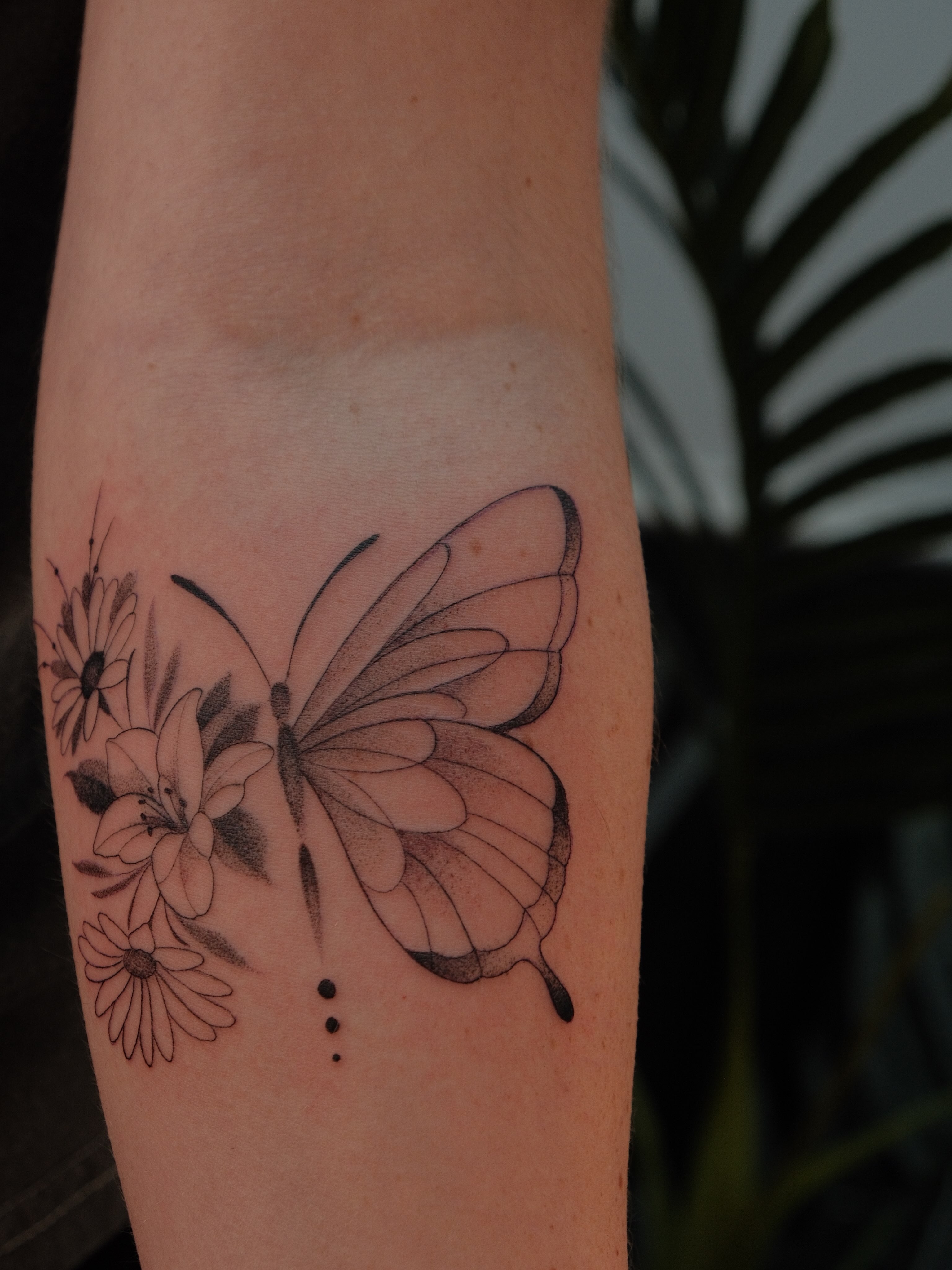 Butterfly and flowers dotwork tattoo on the forearm by JoeyJazz